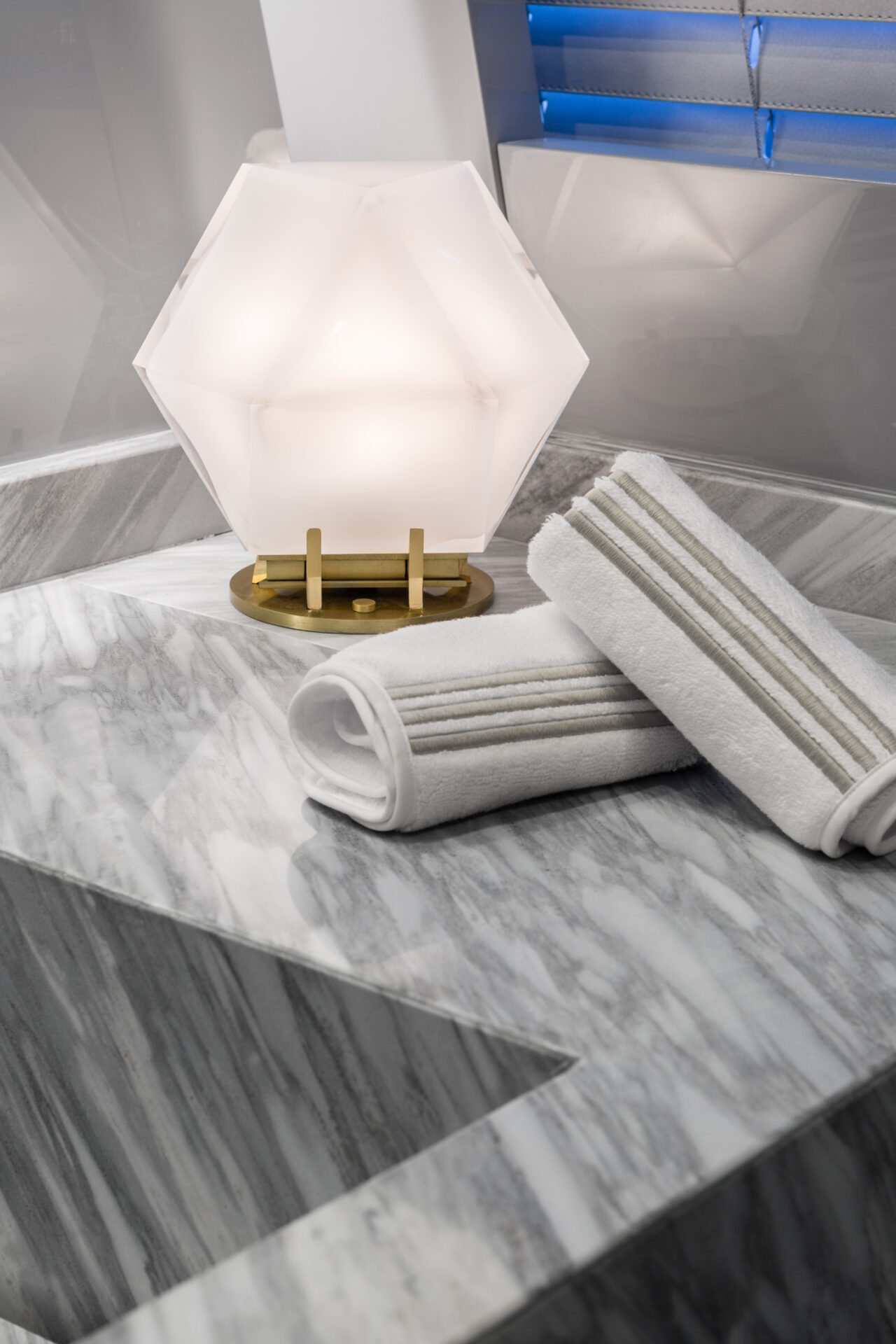 Luxurious marble bathroom with elegant lighting.