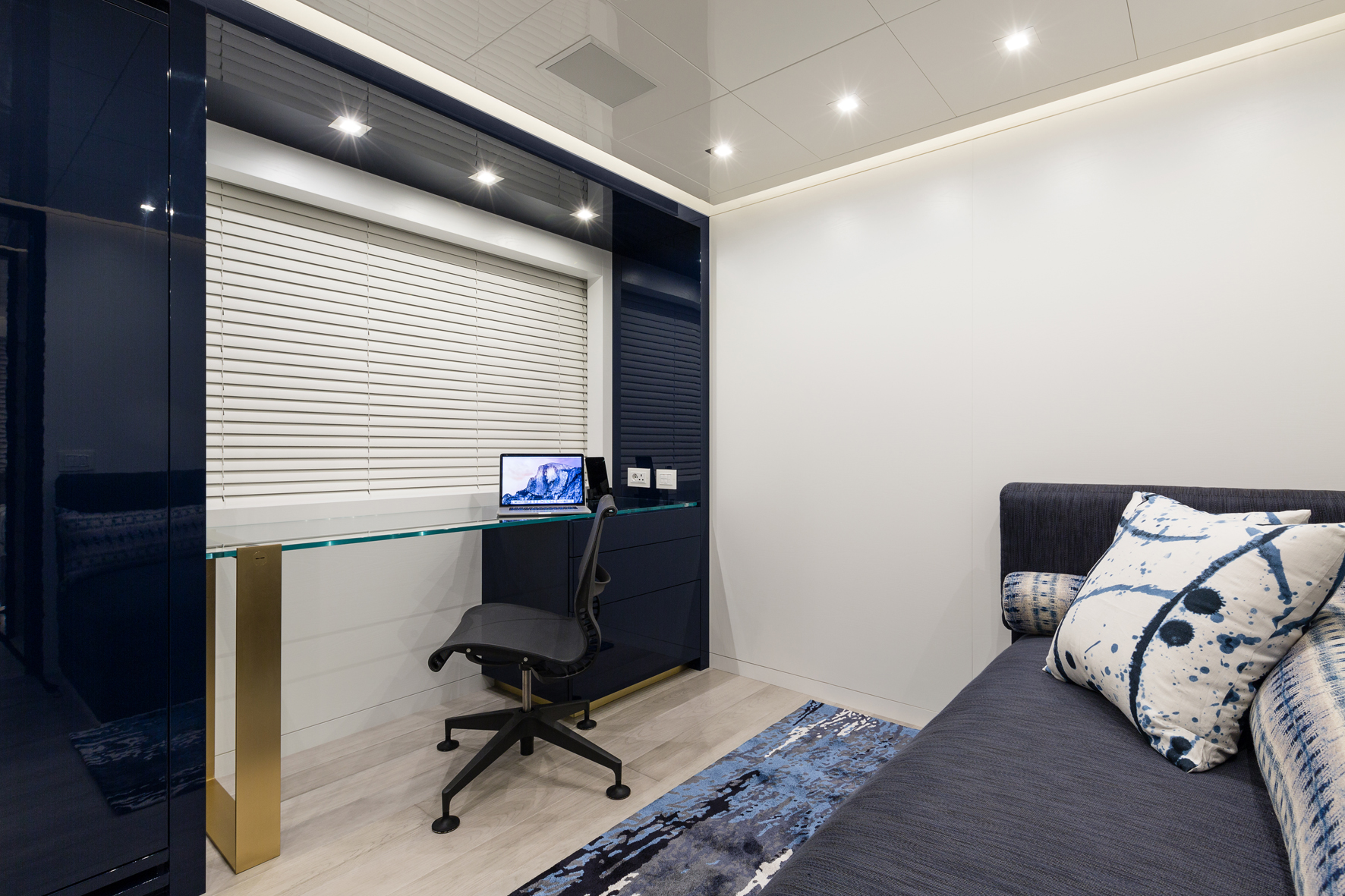 Modern yacht interior with desk and sleek design.