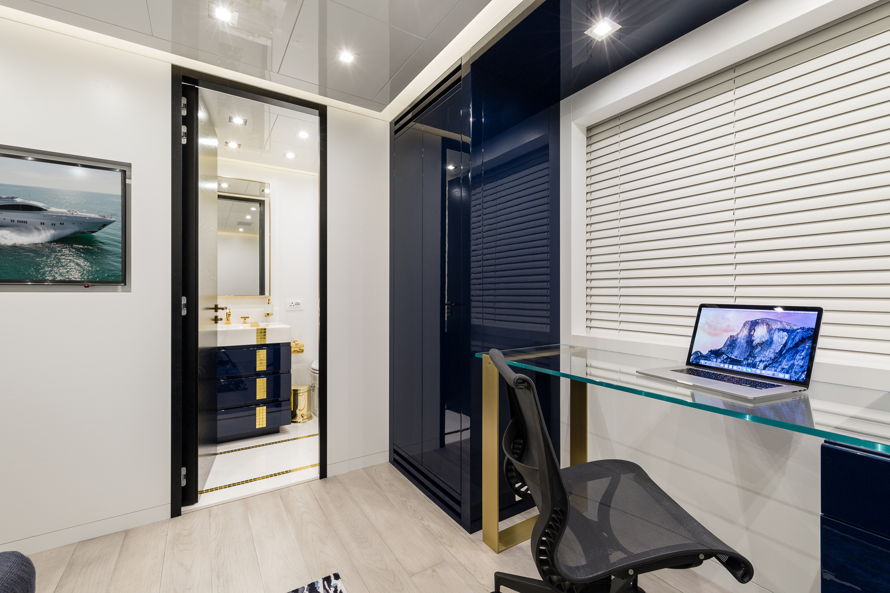 Modern yacht interior with office and luxury bathroom.