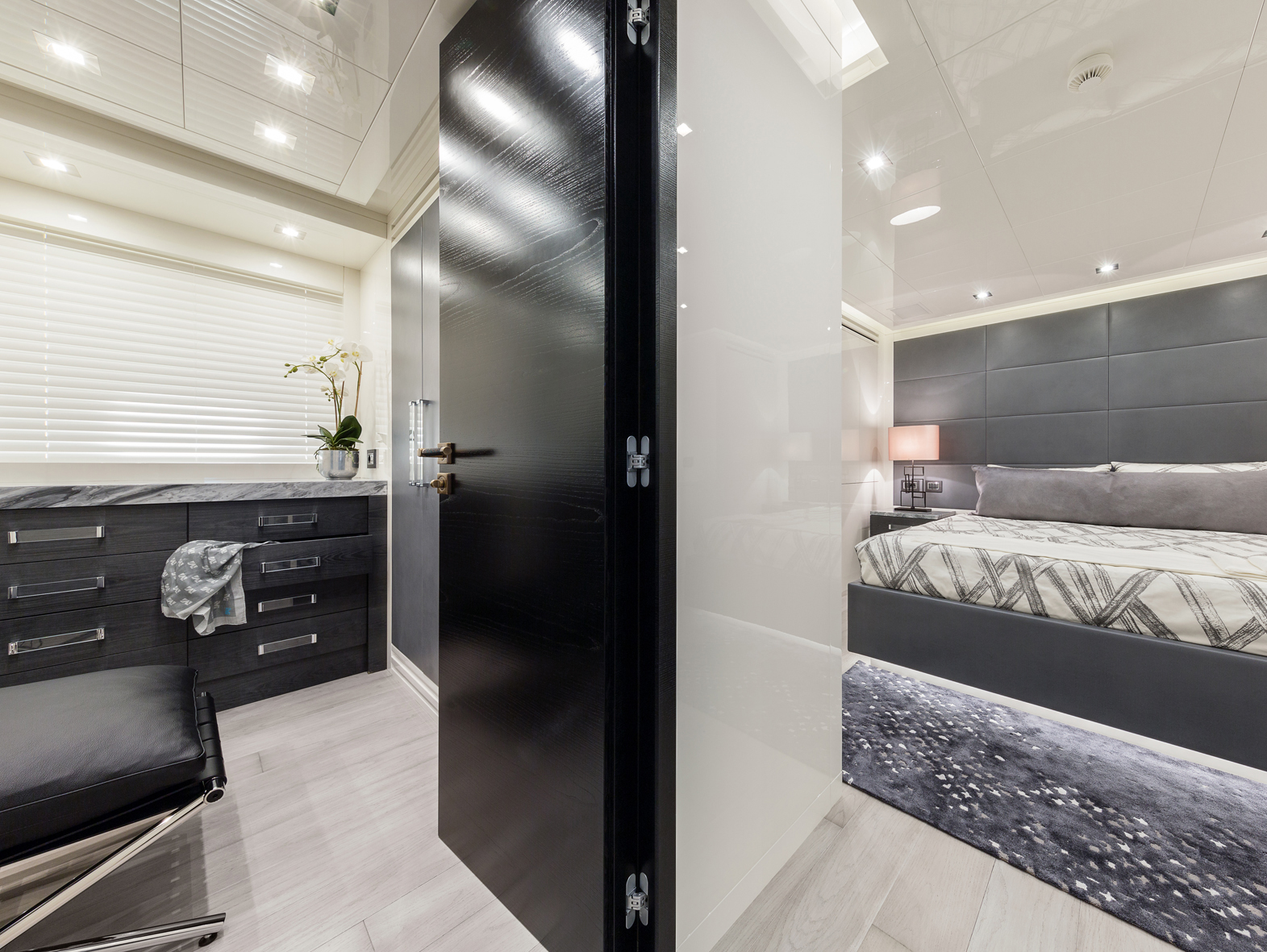Luxurious yacht interior with sleek bedroom design.