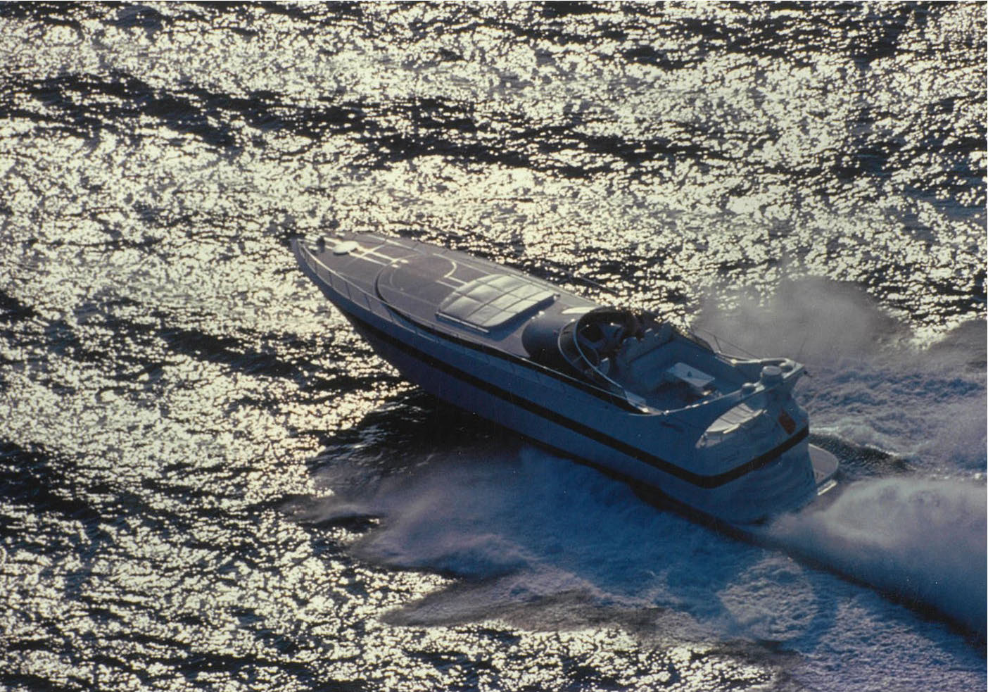 Mangusta yacht cruising at high speed on ocean.