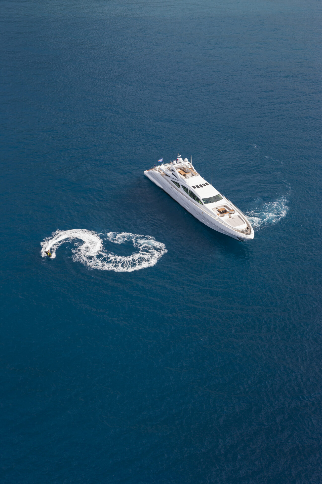 Mangusta Yacht cruising with jet ski nearby