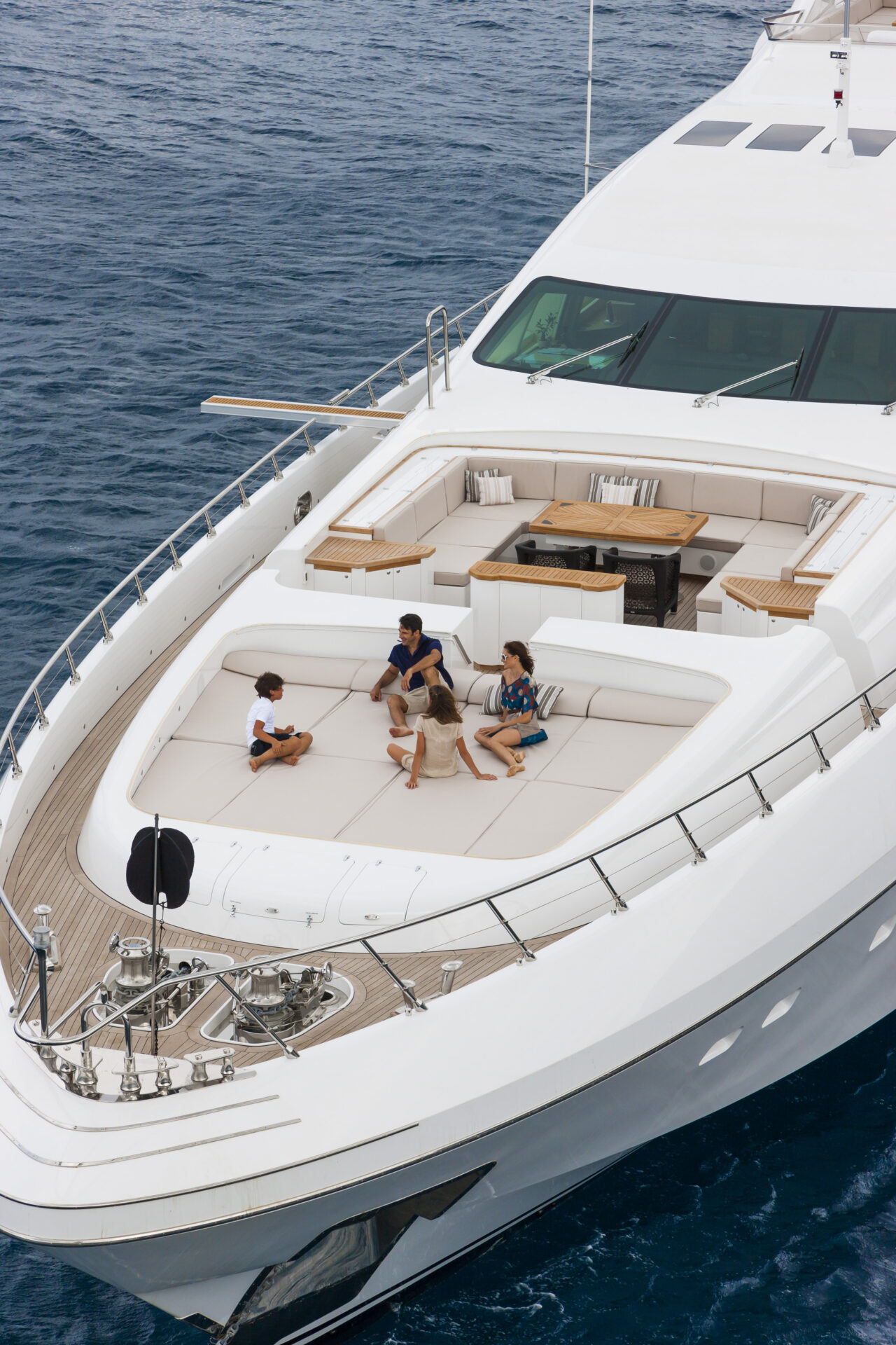 Family enjoying relaxation on Mangusta yacht deck.