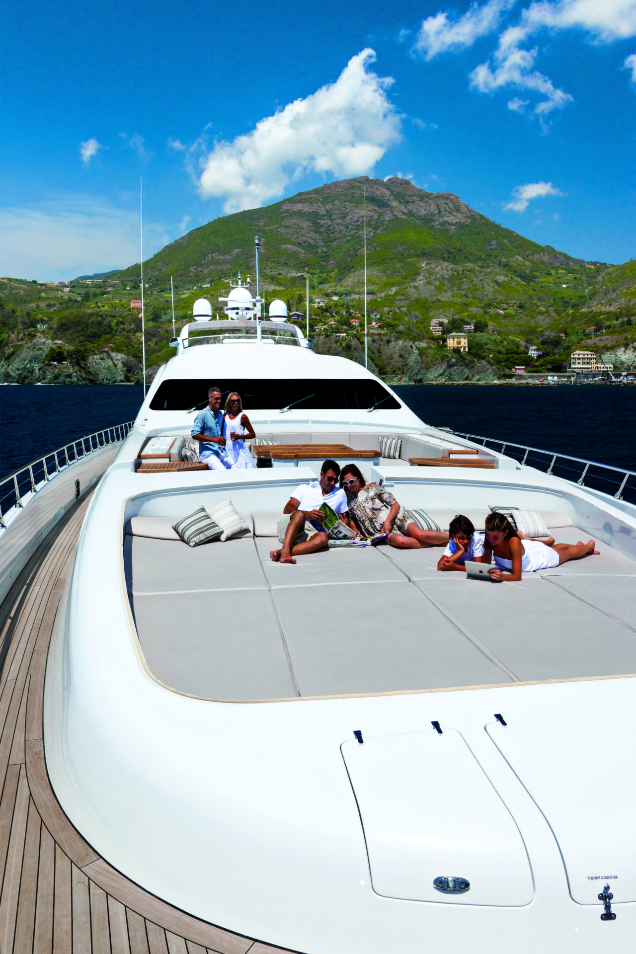Family relaxing on deck of luxury Mangusta yacht