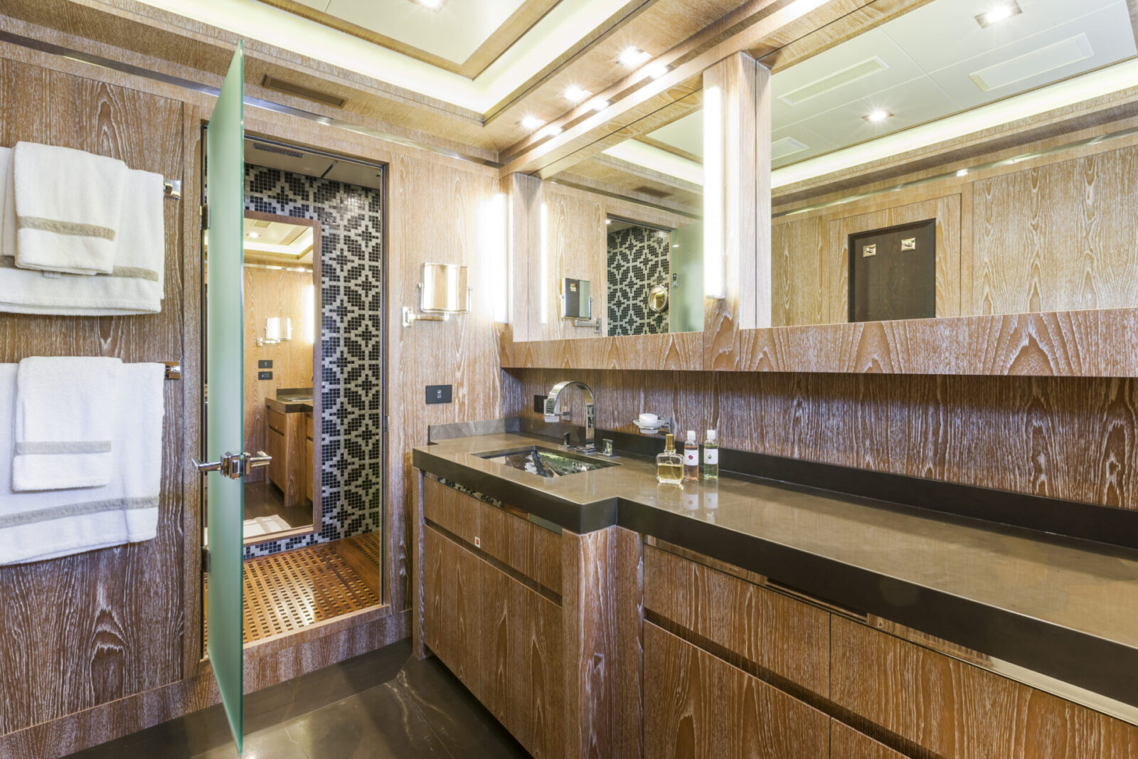 Luxury yacht bathroom with wooden decor and modern fixtures.