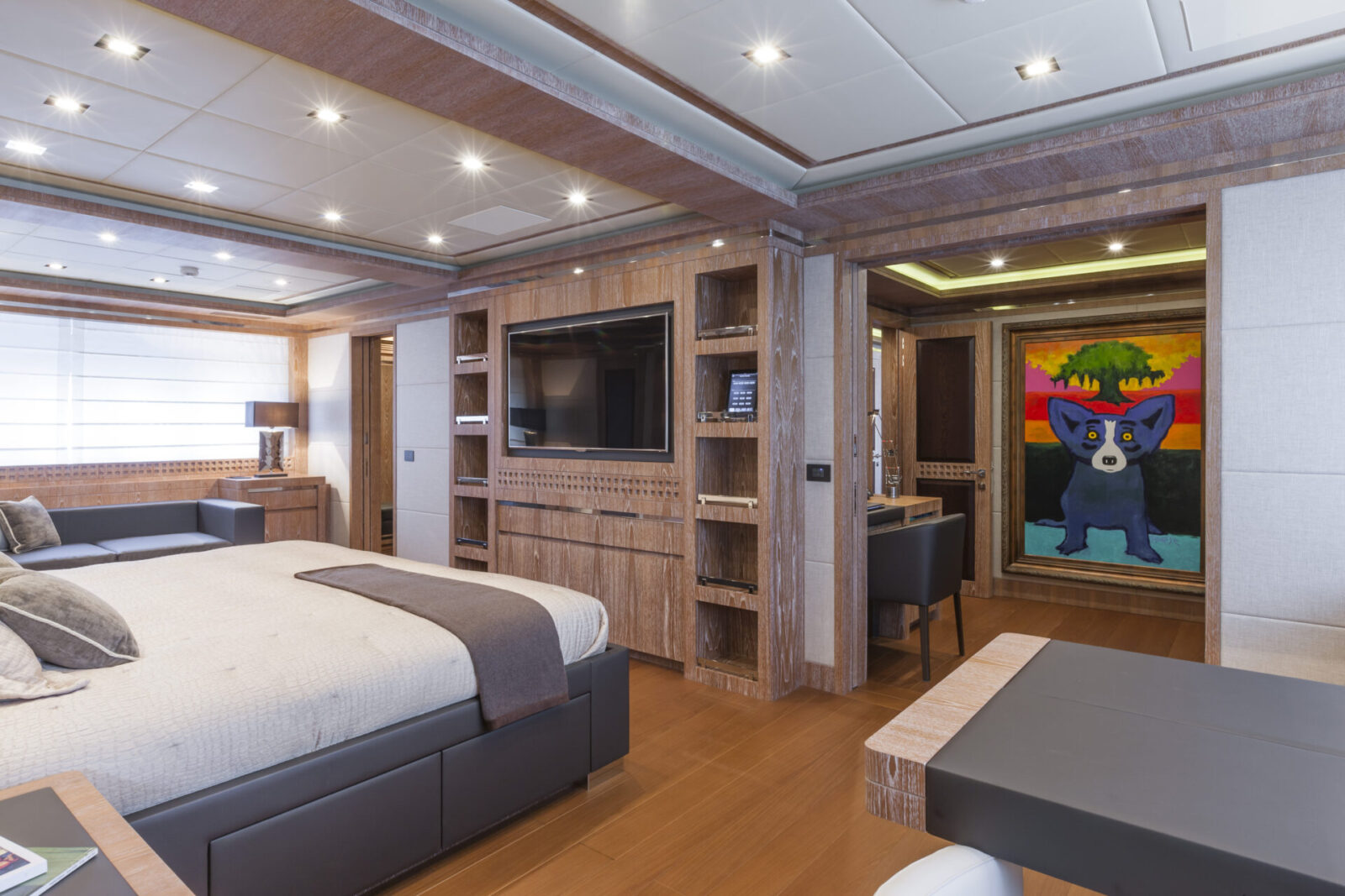 Luxury yacht bedroom with modern decor and artwork.