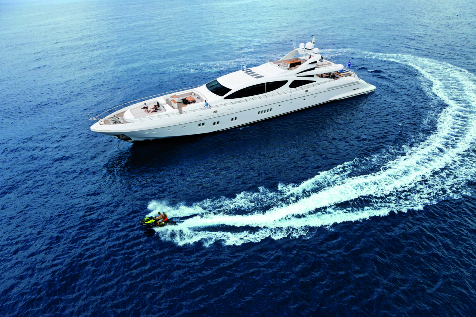 Mangusta yacht cruising with jet ski nearby