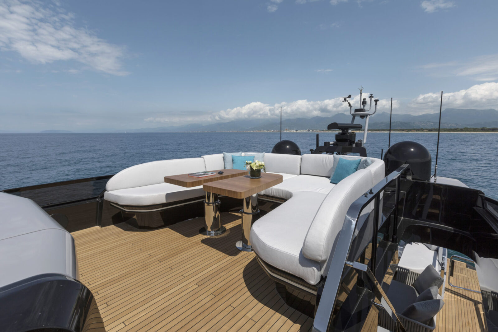 Luxury yacht deck with ocean view and seating.
