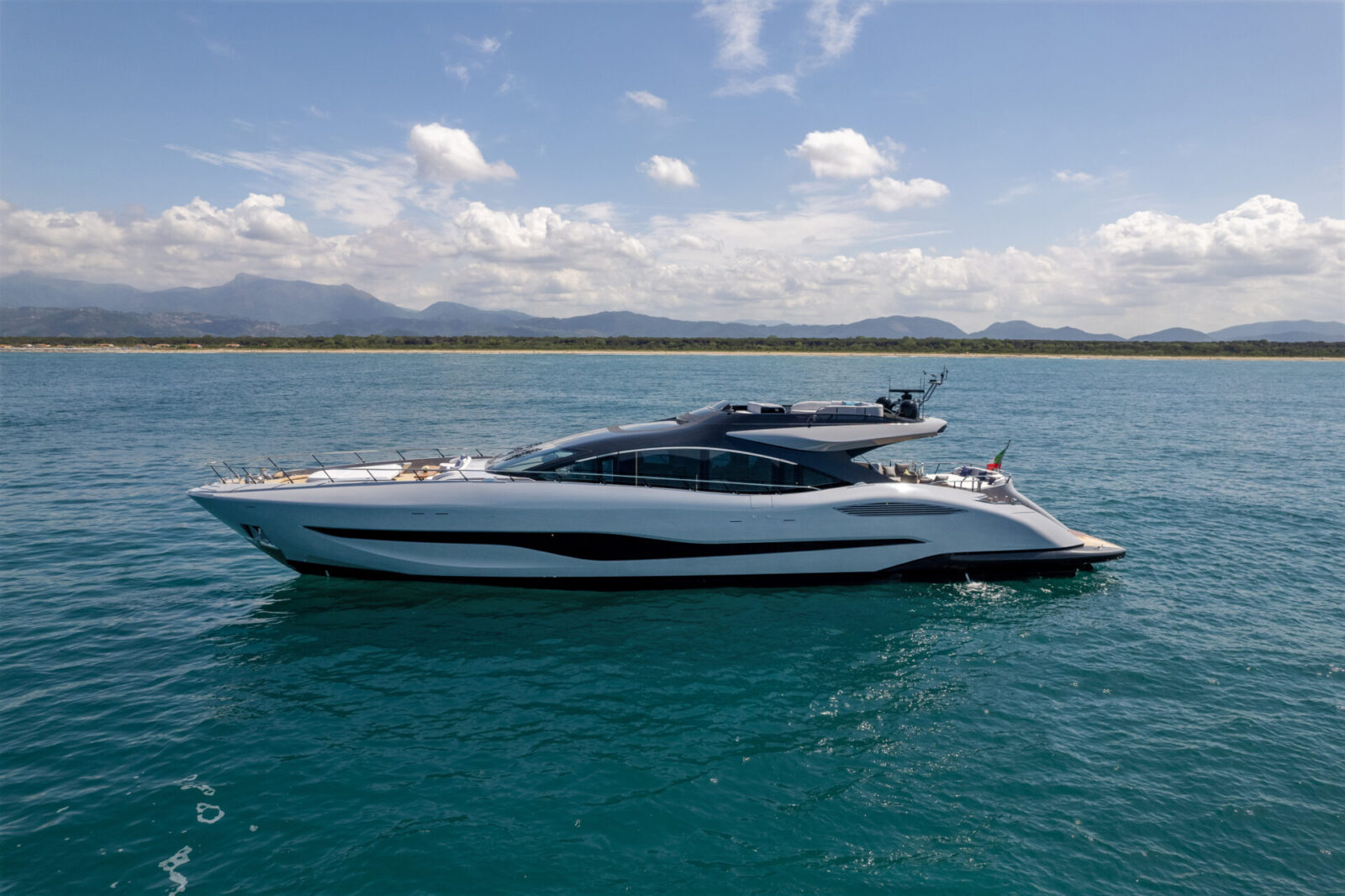 Luxury Mangusta yacht cruising on open sea.