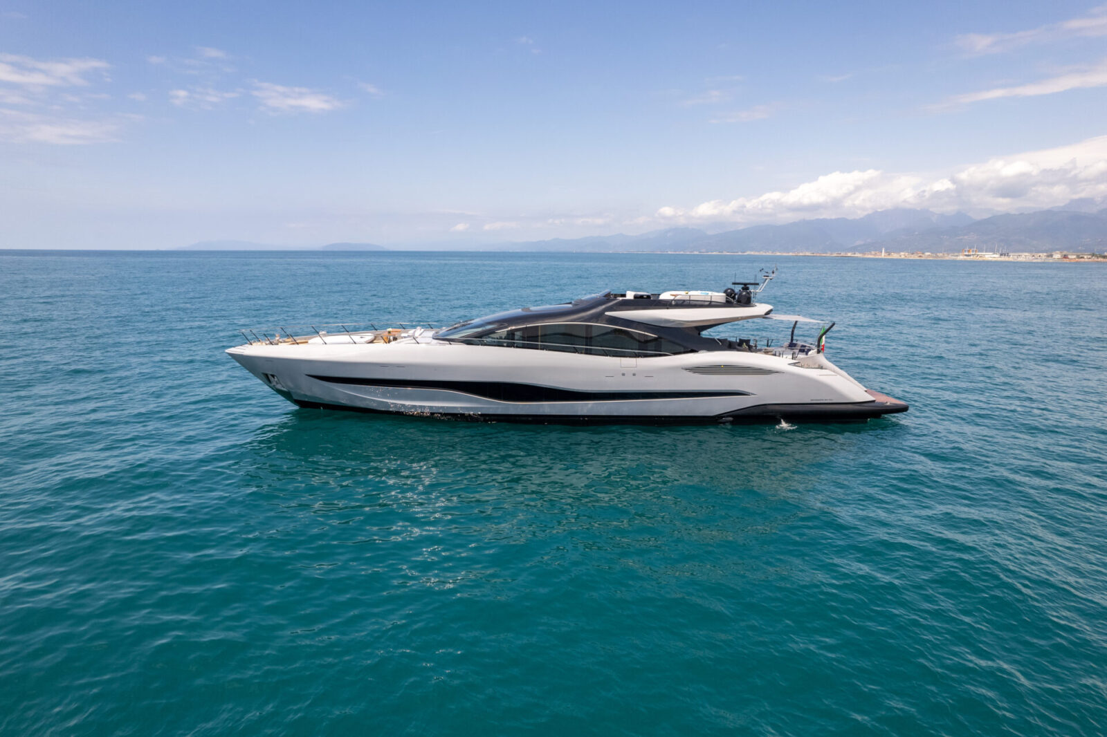 Mangusta yacht cruising on clear blue waters.