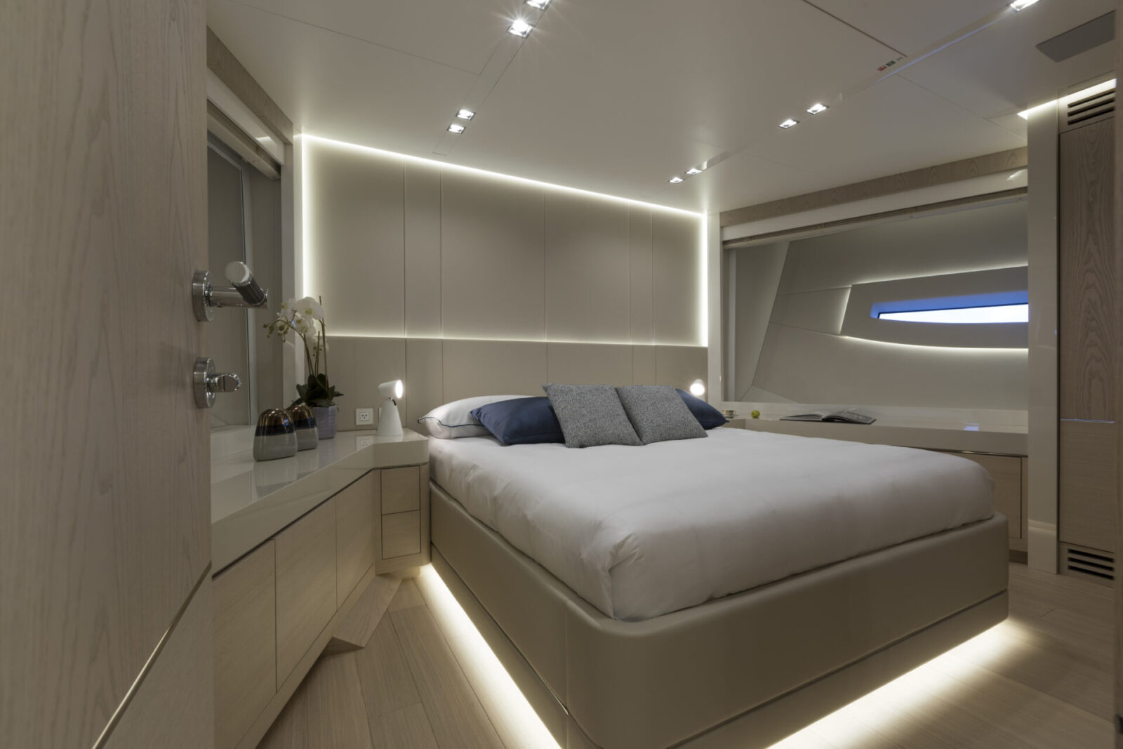 Luxurious yacht bedroom with modern lighting.