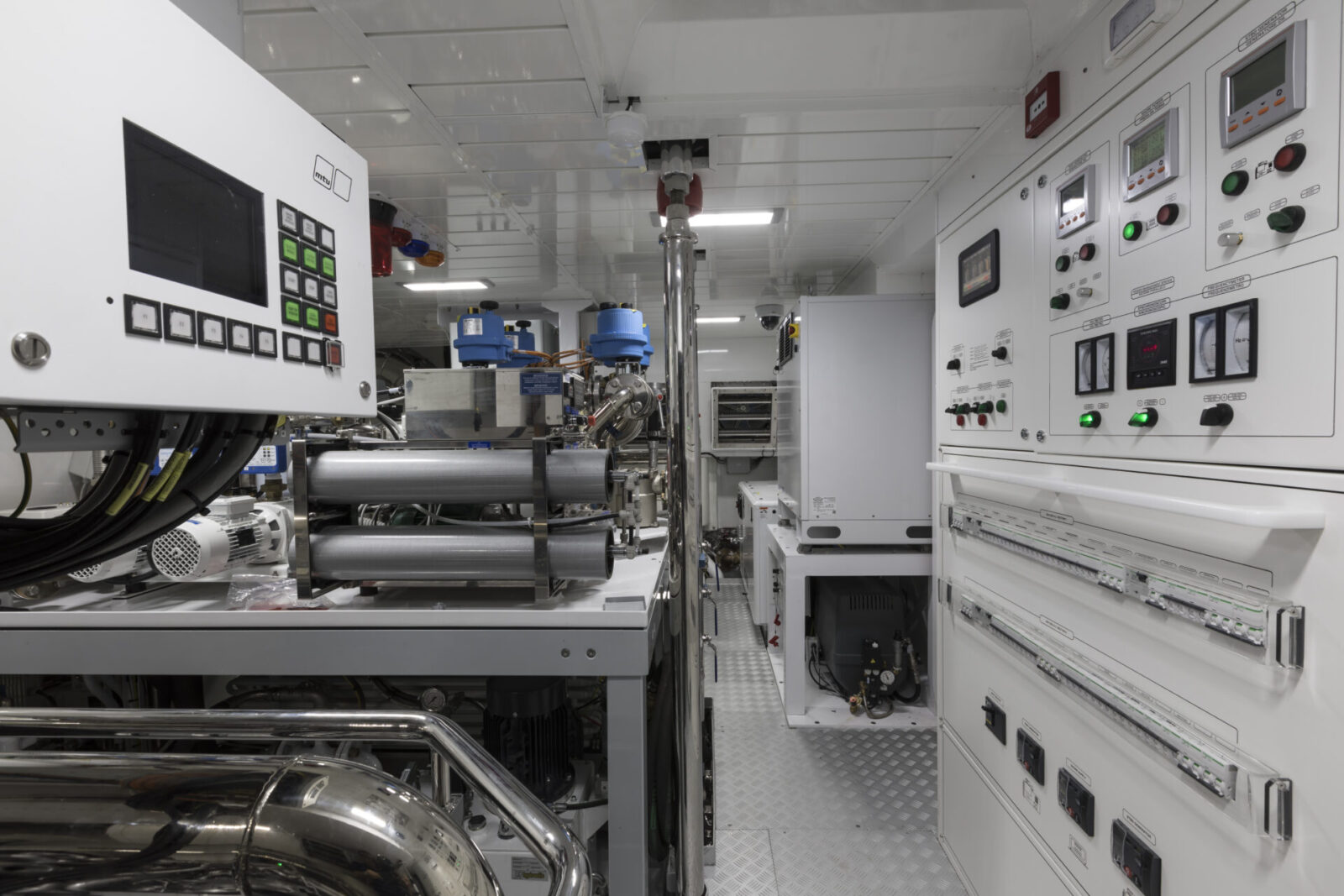 Yacht engine room with control panels and machinery