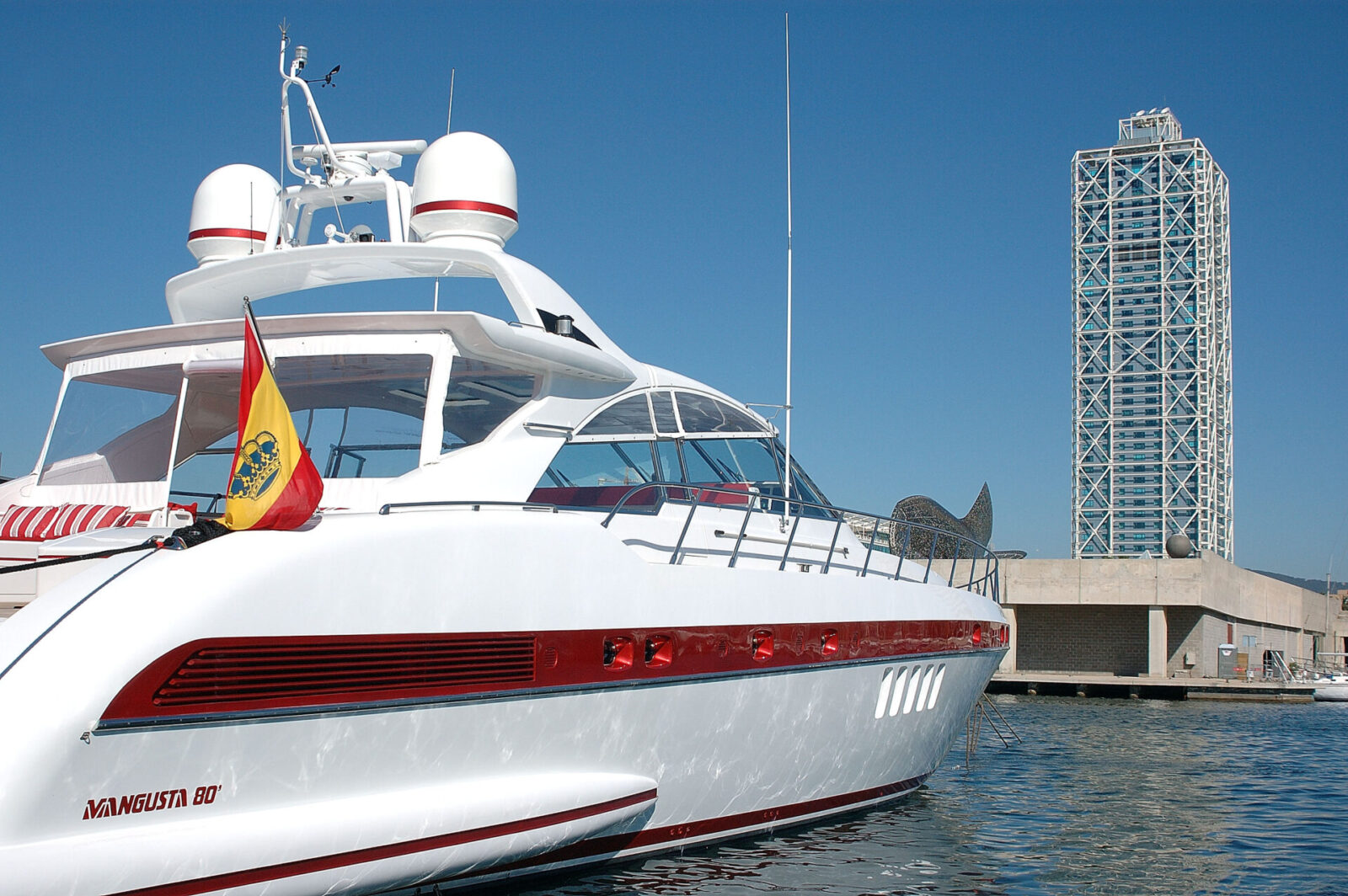 Mangusta yacht docked near Barcelona tower