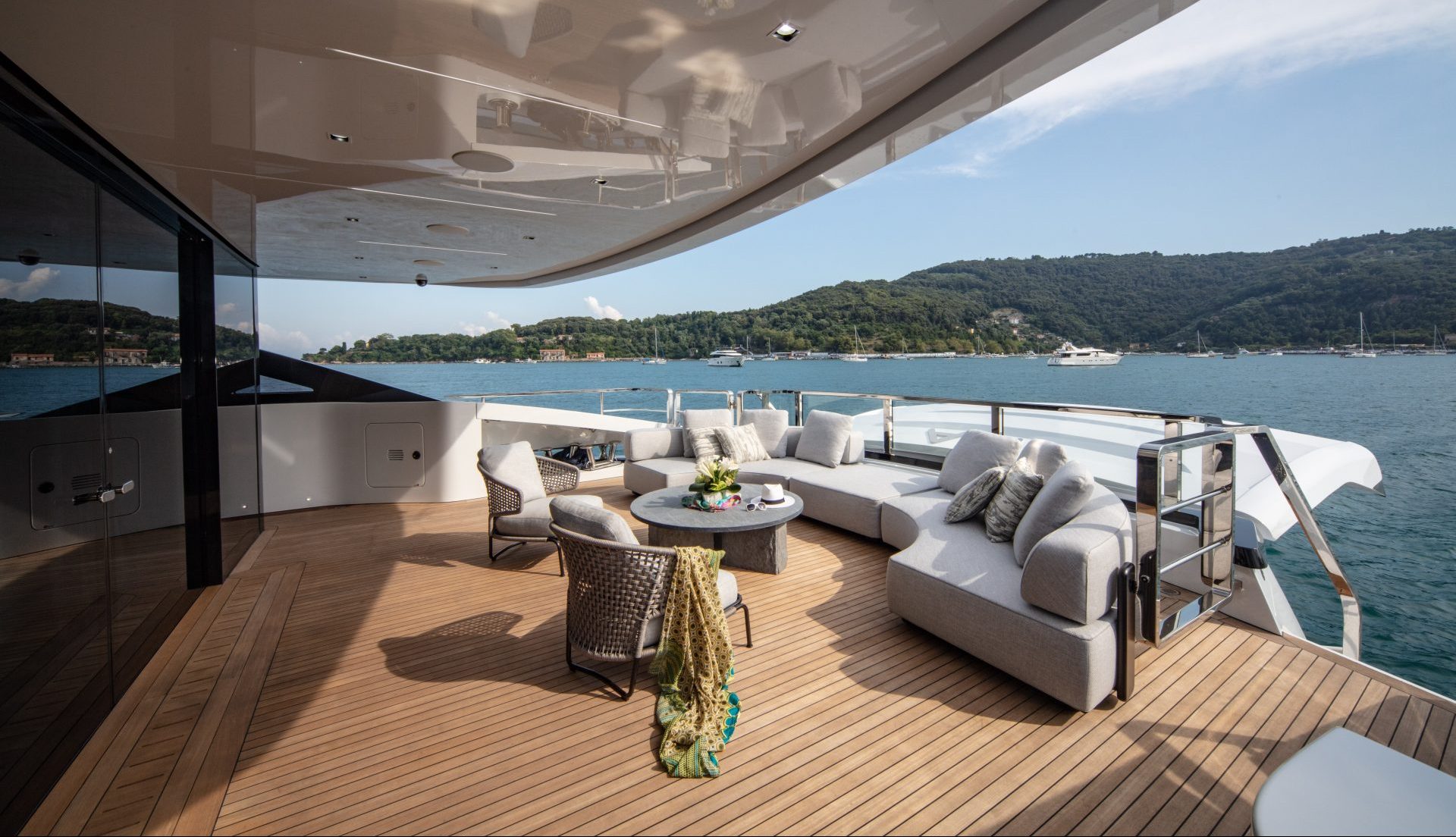 Elegant deck lounge on Mangusta yacht with sea view.