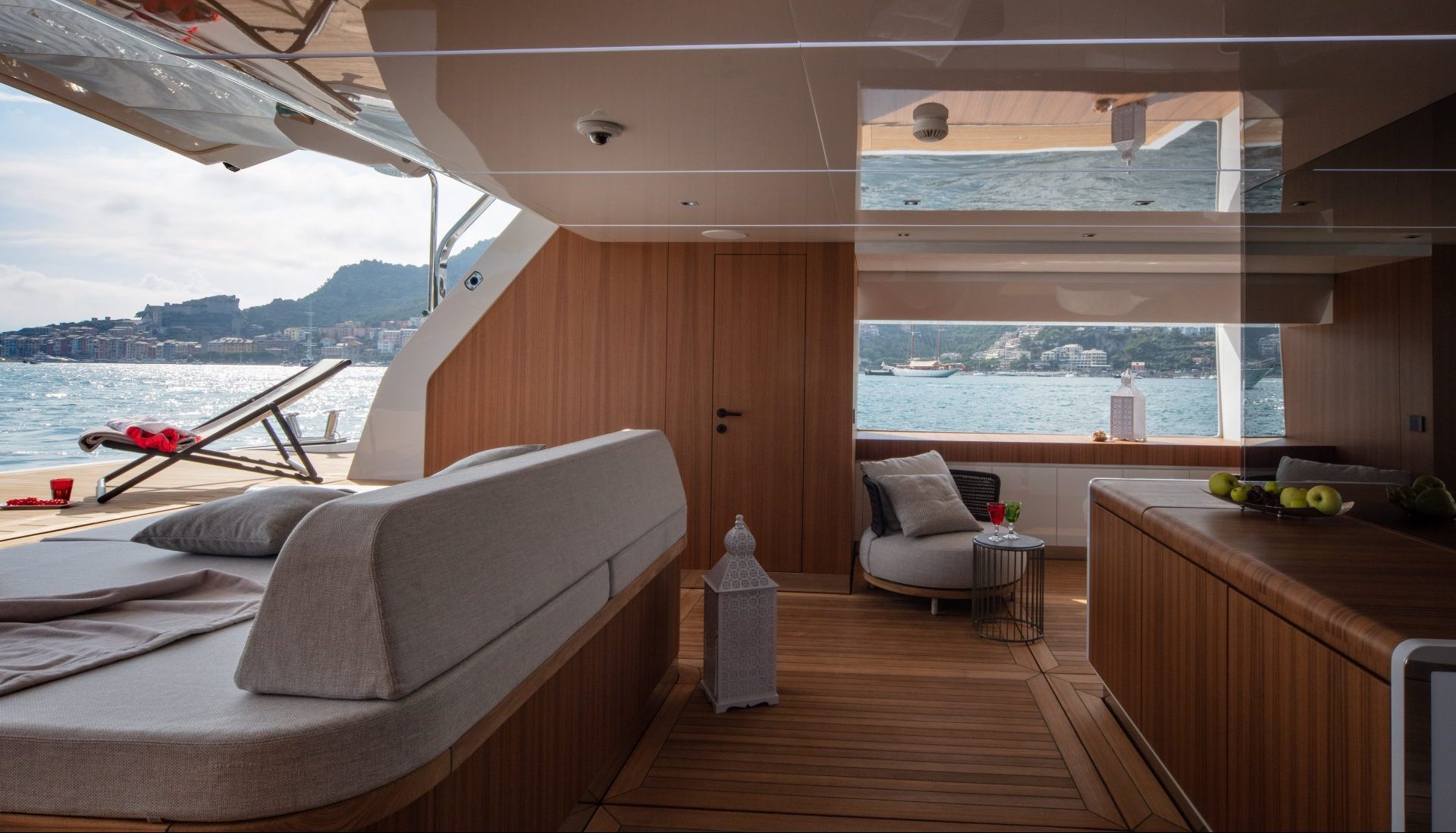 Elegant yacht interior with sea view and wooden furnishings.