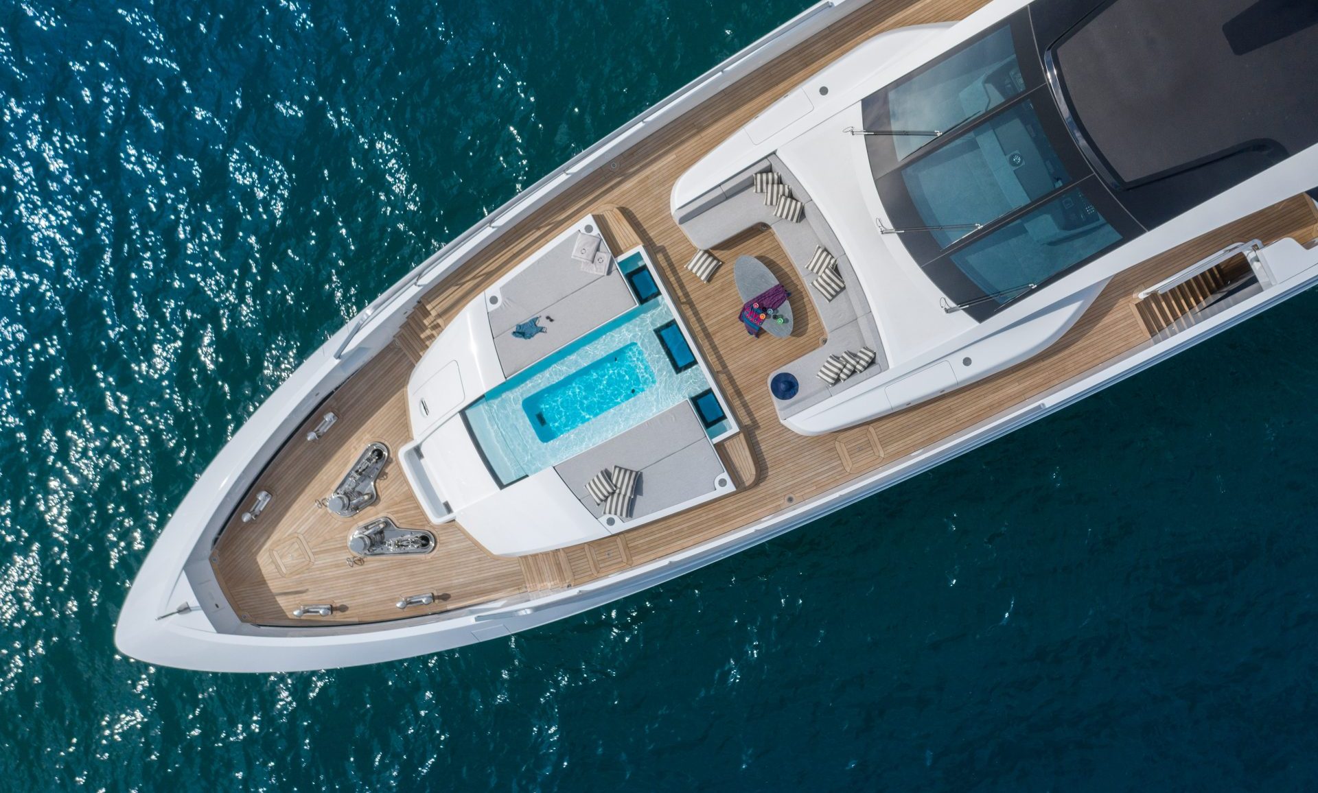 Luxury yacht deck with pool by Mangusta Yachts.