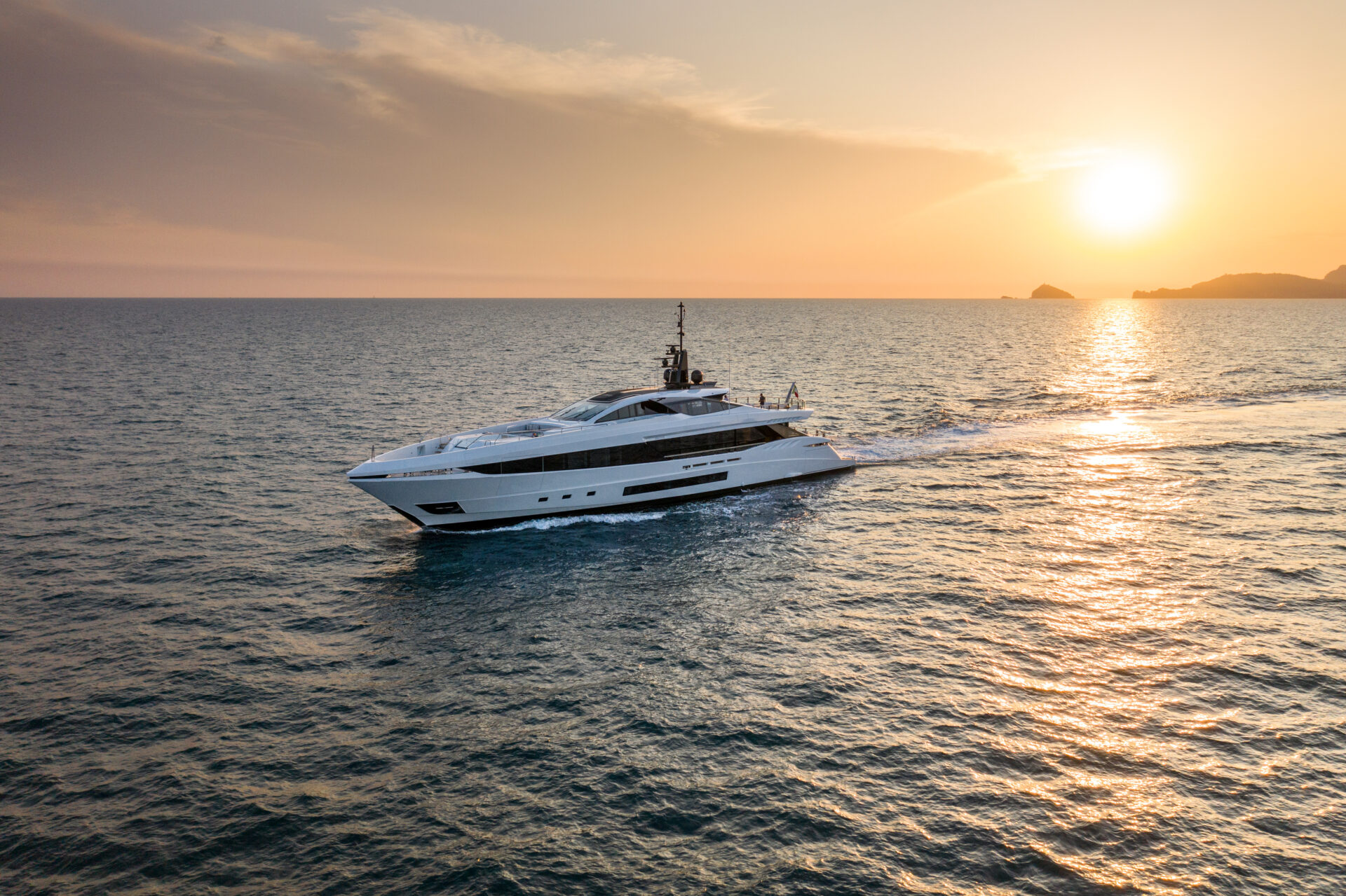 Mangusta yacht cruising at sunset on open sea