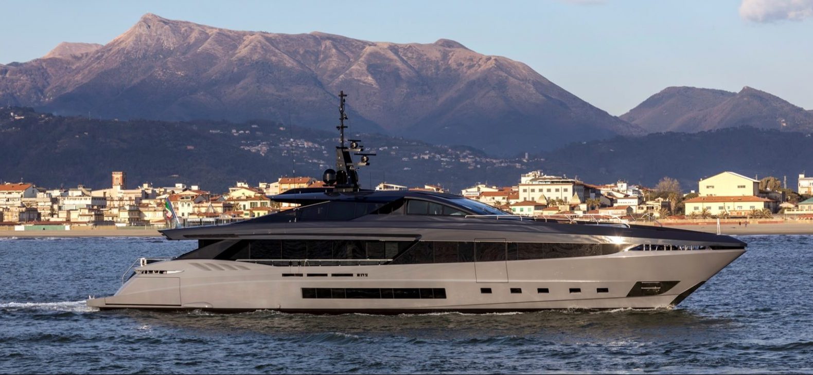 Mangusta yacht cruising near coastal mountains