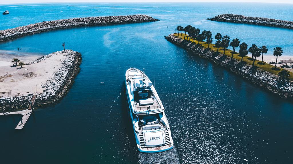 Yacht Mangusta naviga in mare aperto con palme.