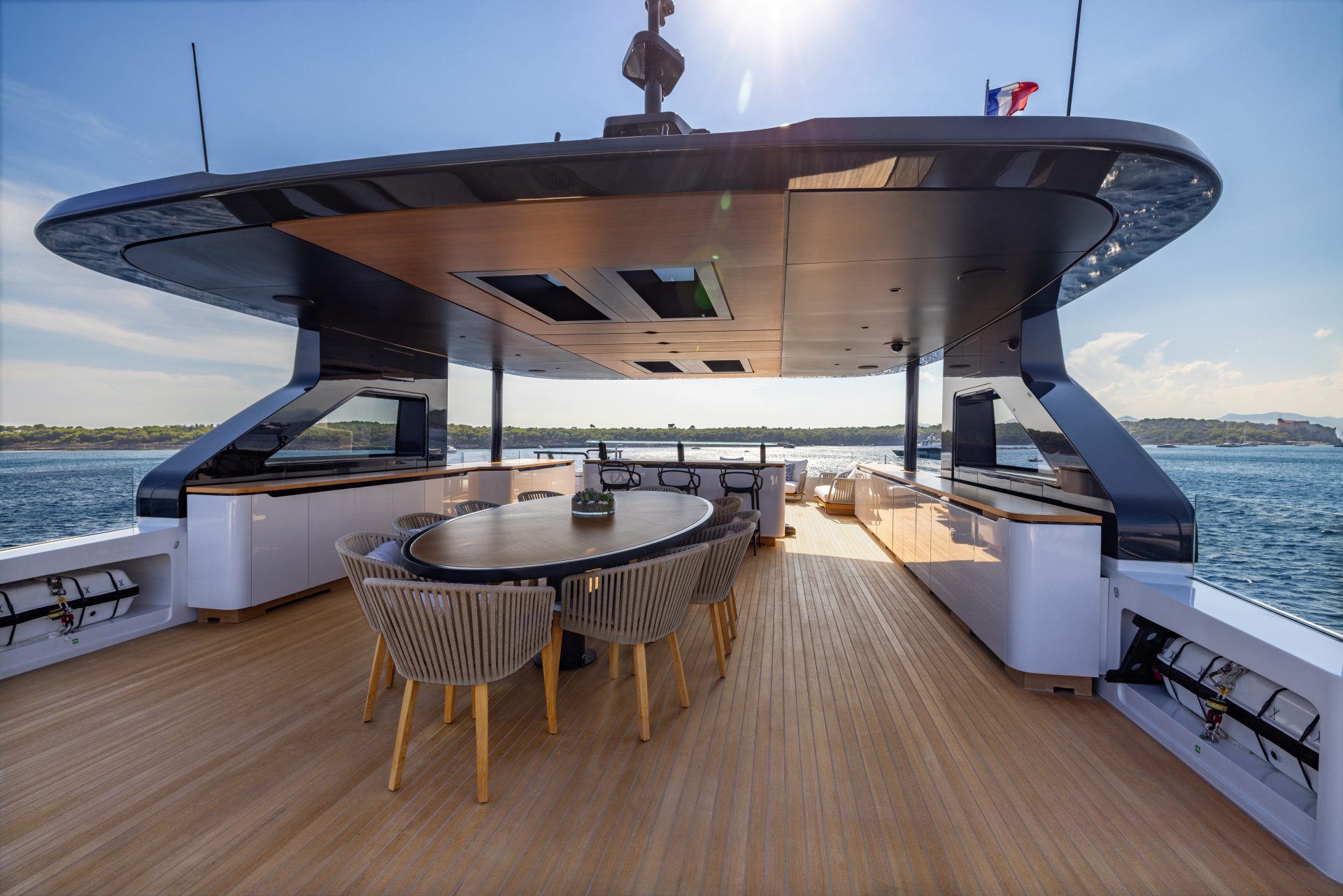 Luxury yacht deck with dining area and sea view