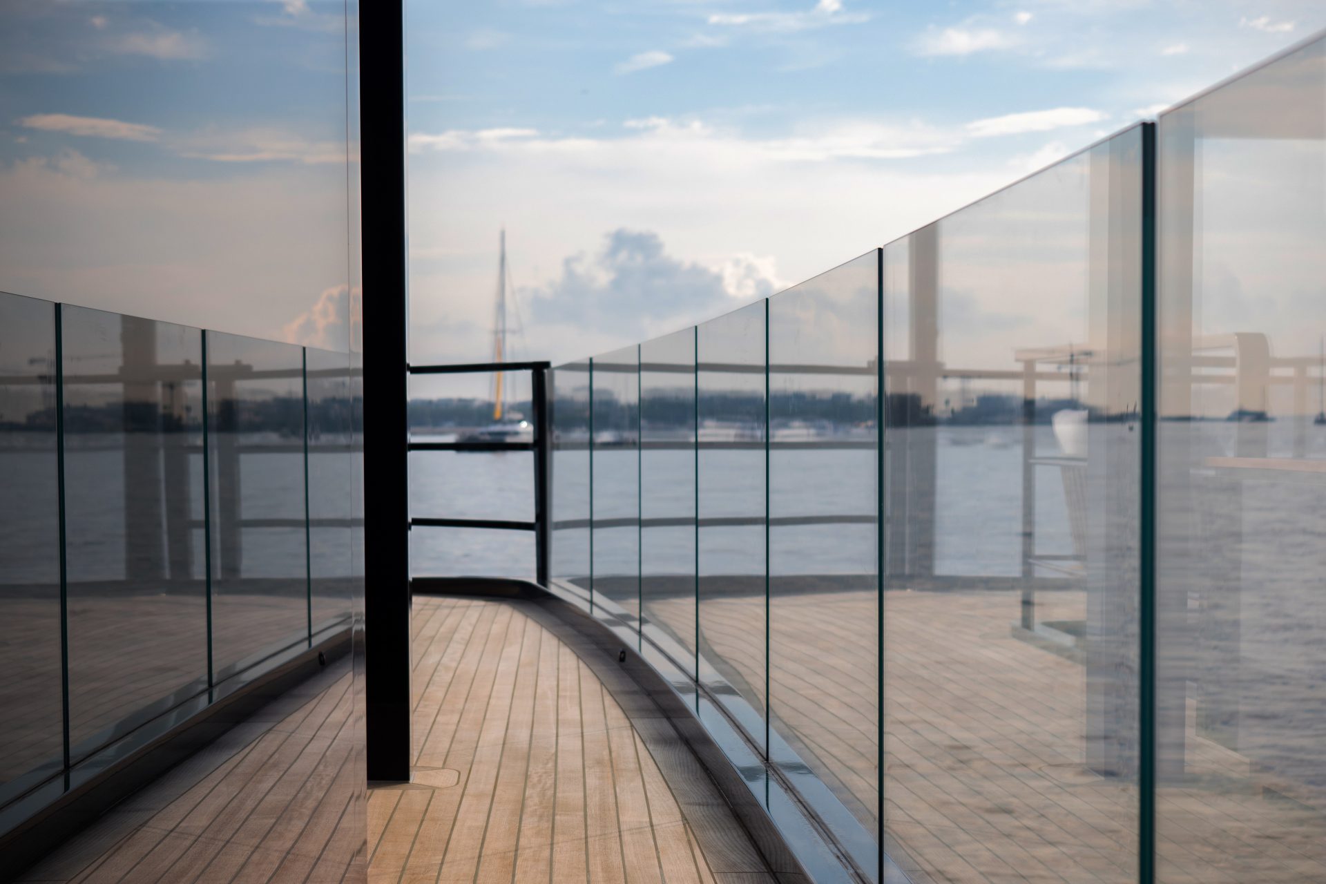 Mangusta Yacht deck with glass railing at sea