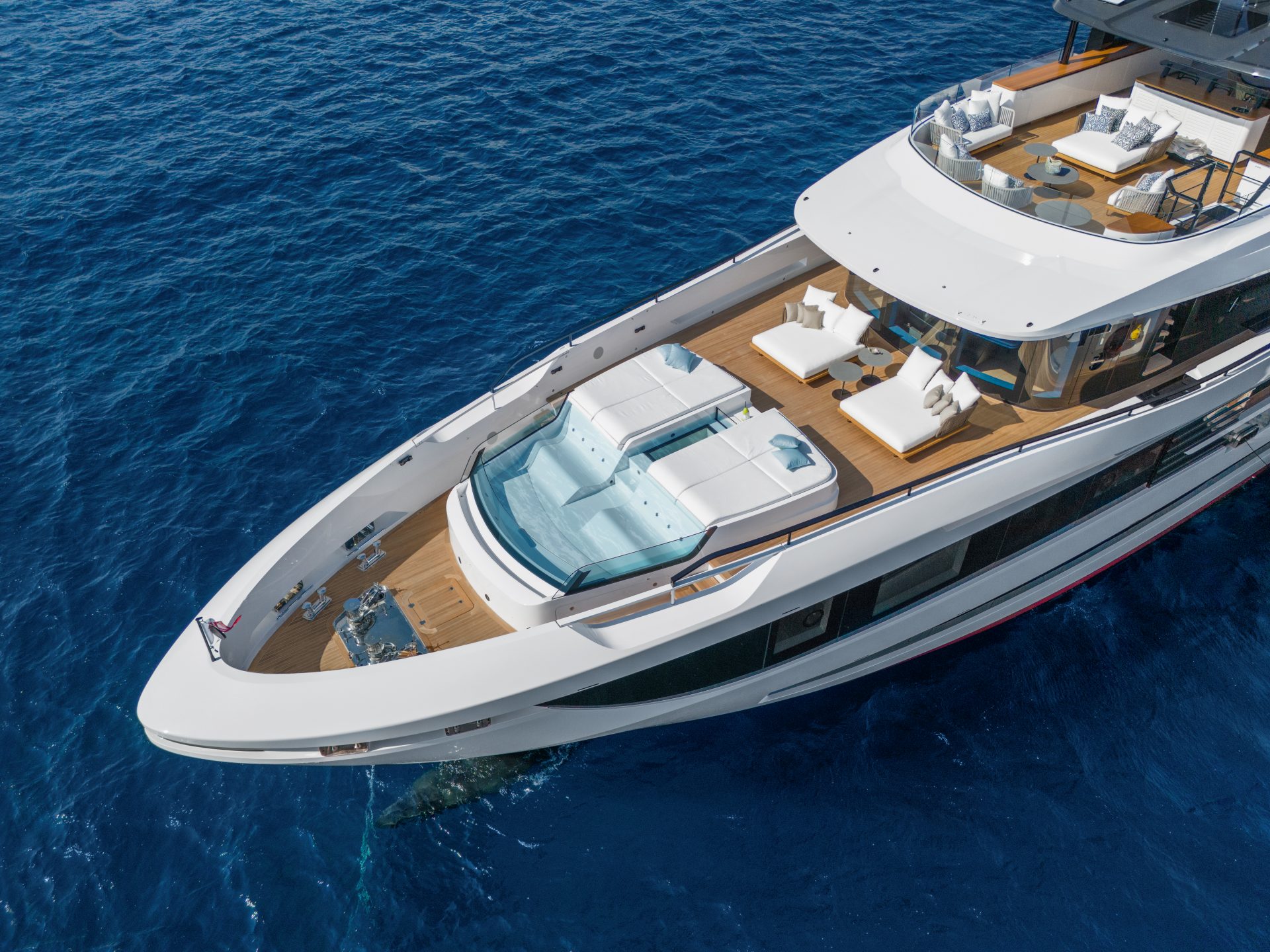 Luxury Mangusta yacht with deck jacuzzi and loungers.