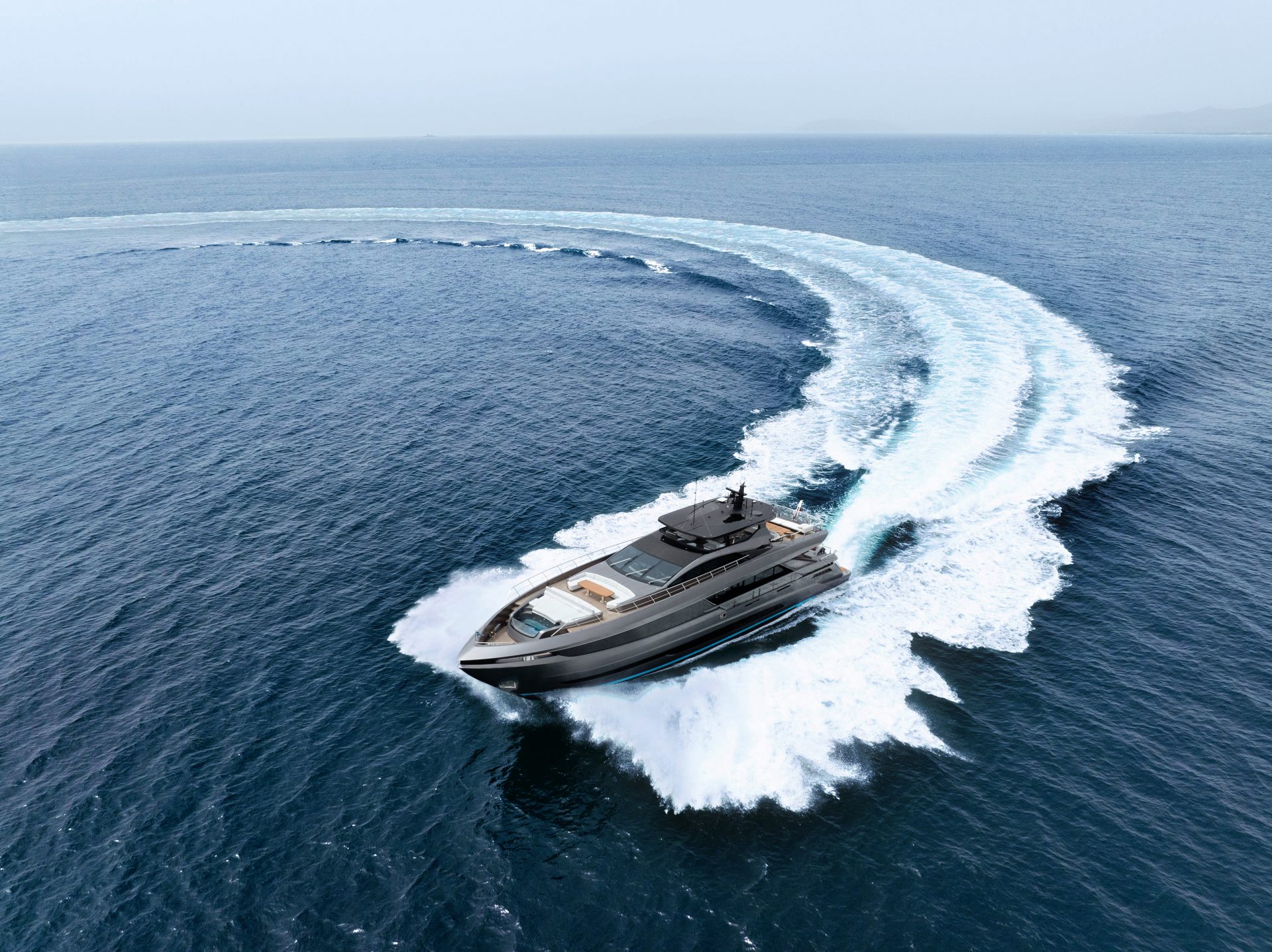 Mangusta Yacht cruising in open sea, making a sharp turn.