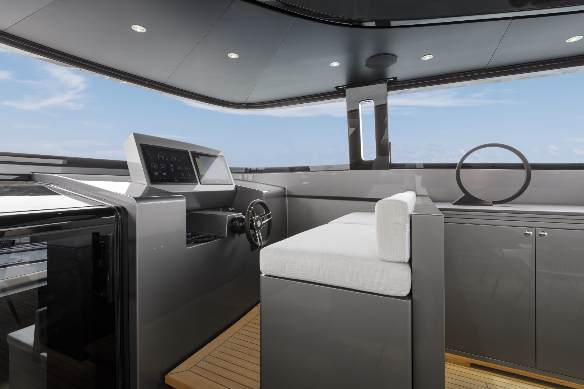 Luxury yacht cockpit with modern steering controls.