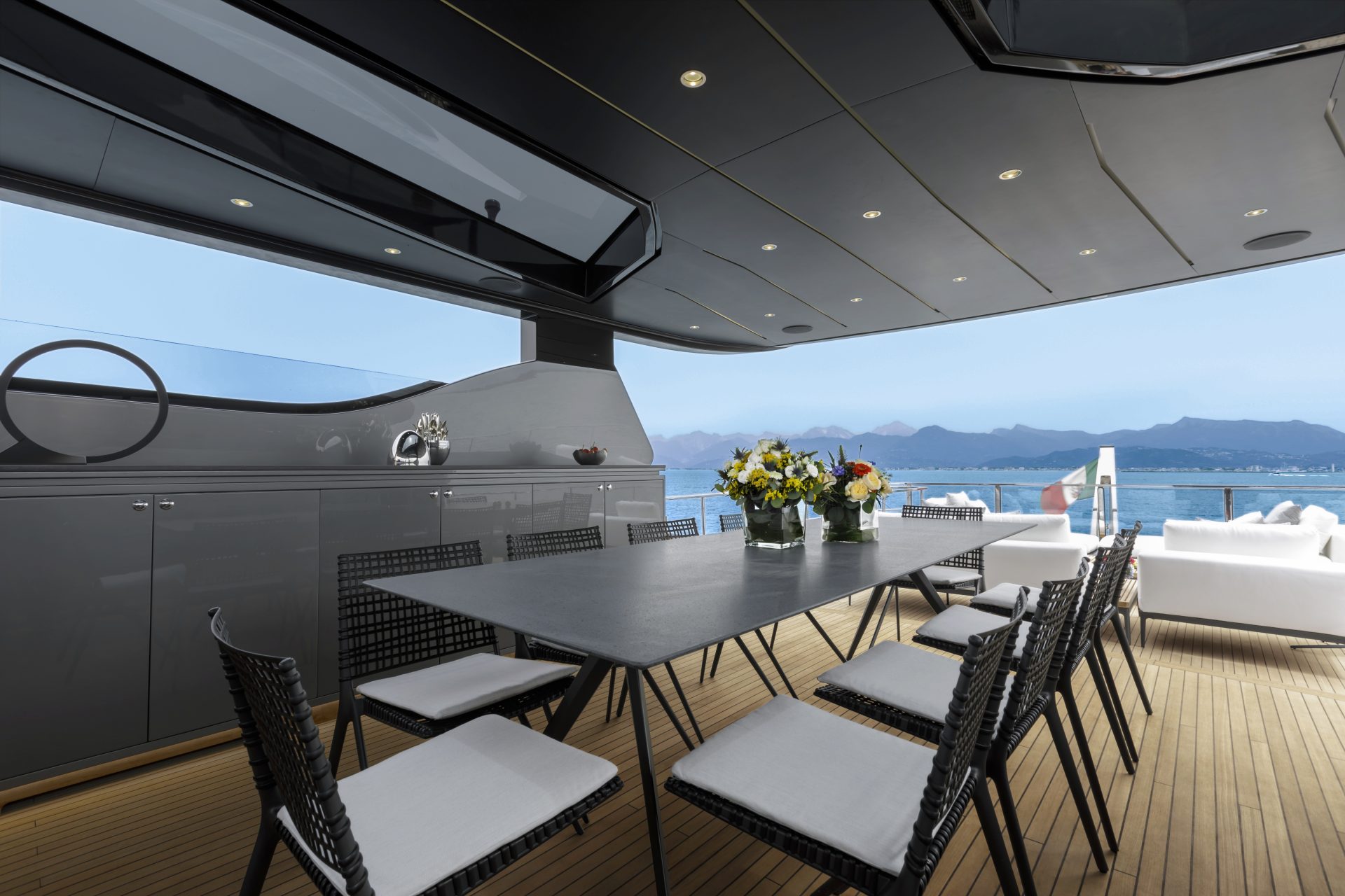 Elegant yacht deck dining area with sea view.