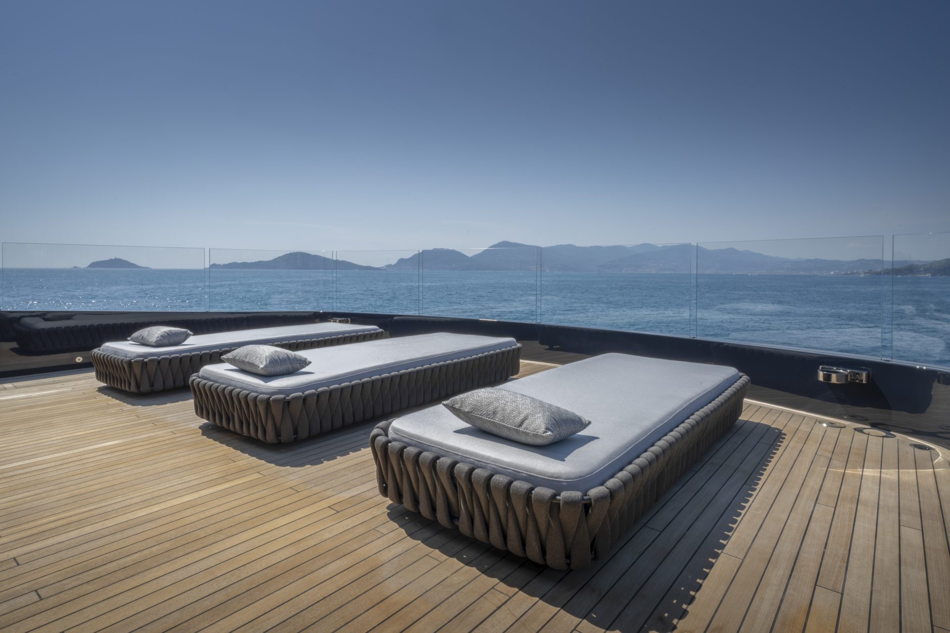 Sun loungers on luxurious yacht deck with sea view
