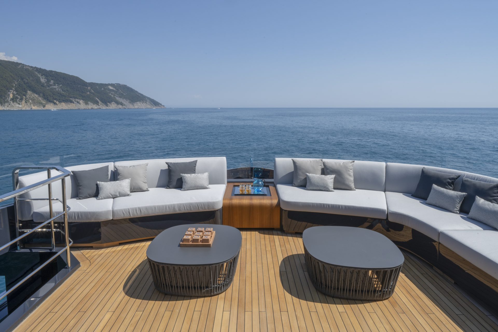 Luxury yacht deck with ocean view and seating area.