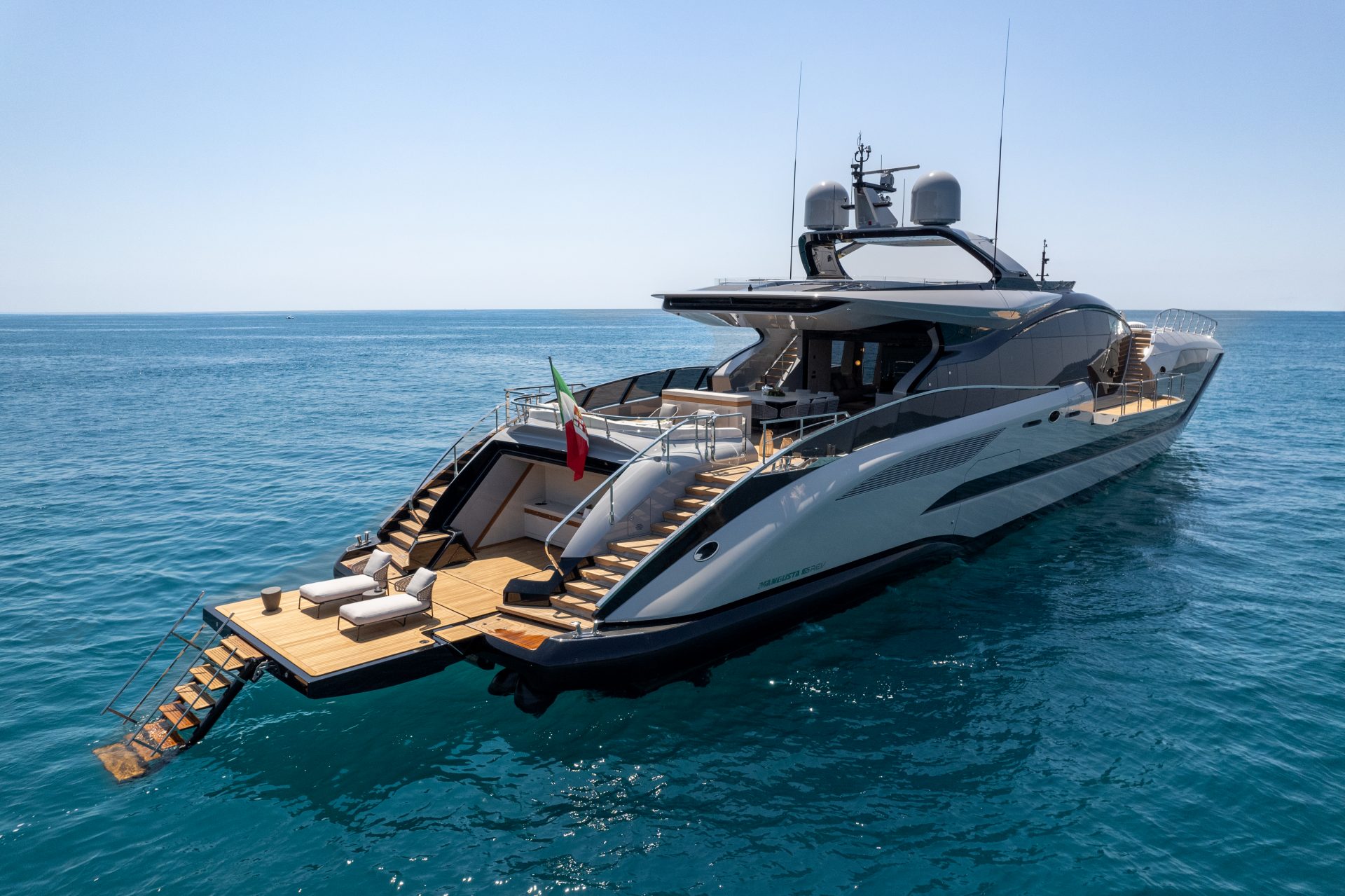 Luxury Mangusta yacht on open sea with sun deck.