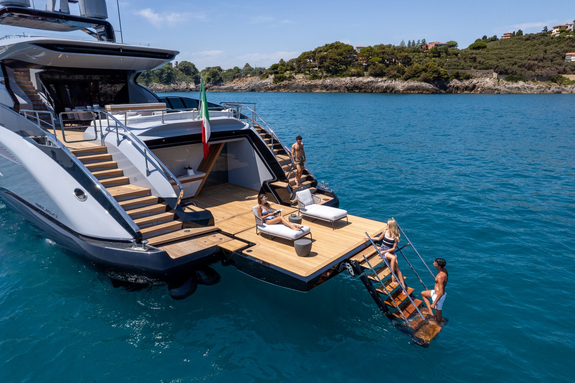 Luxurious Mangusta Yacht with guests relaxing onboard.