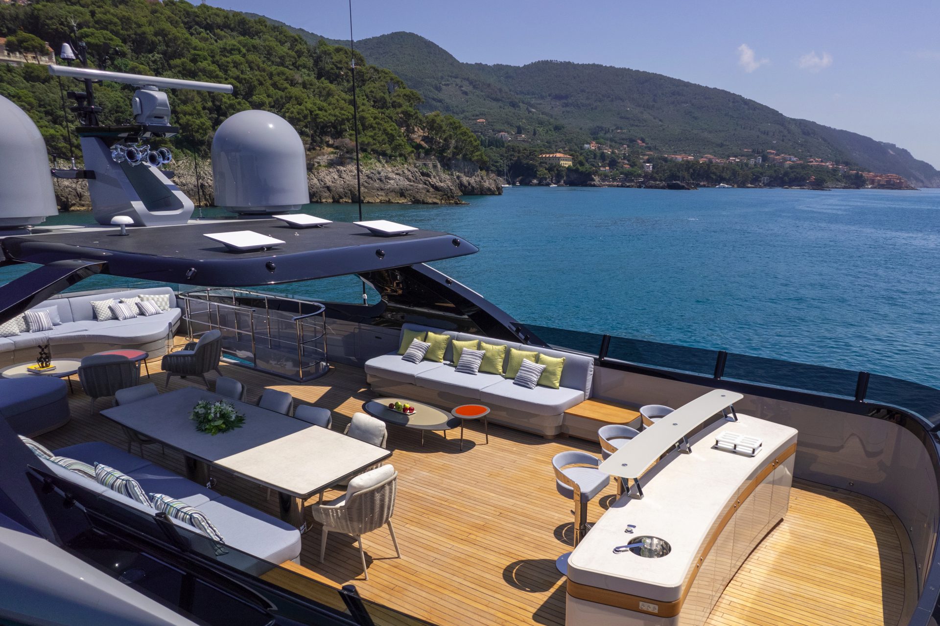 Luxury yacht deck with seating and ocean view.