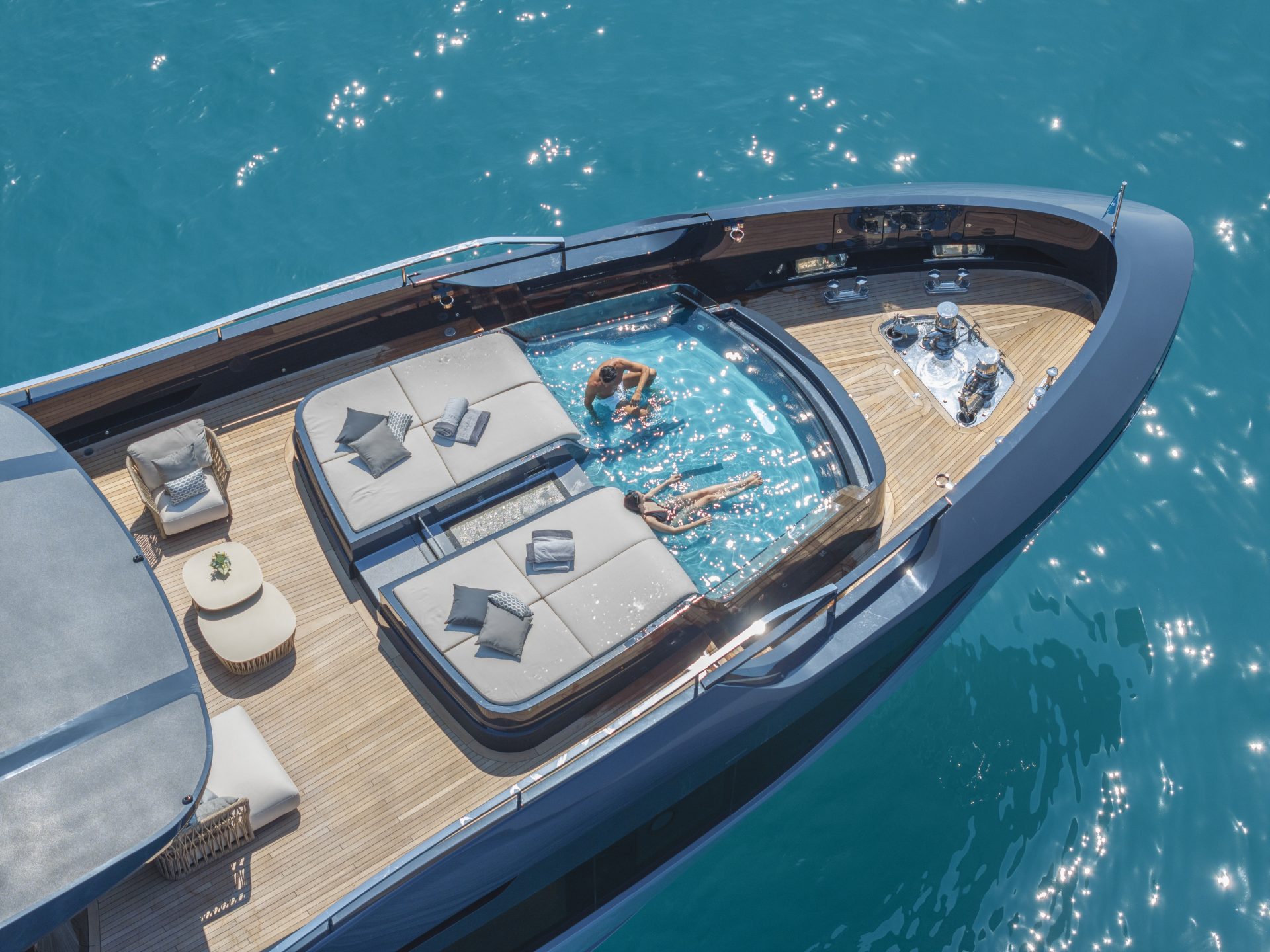 Luxury Mangusta yacht deck with pool and sunbathing area.