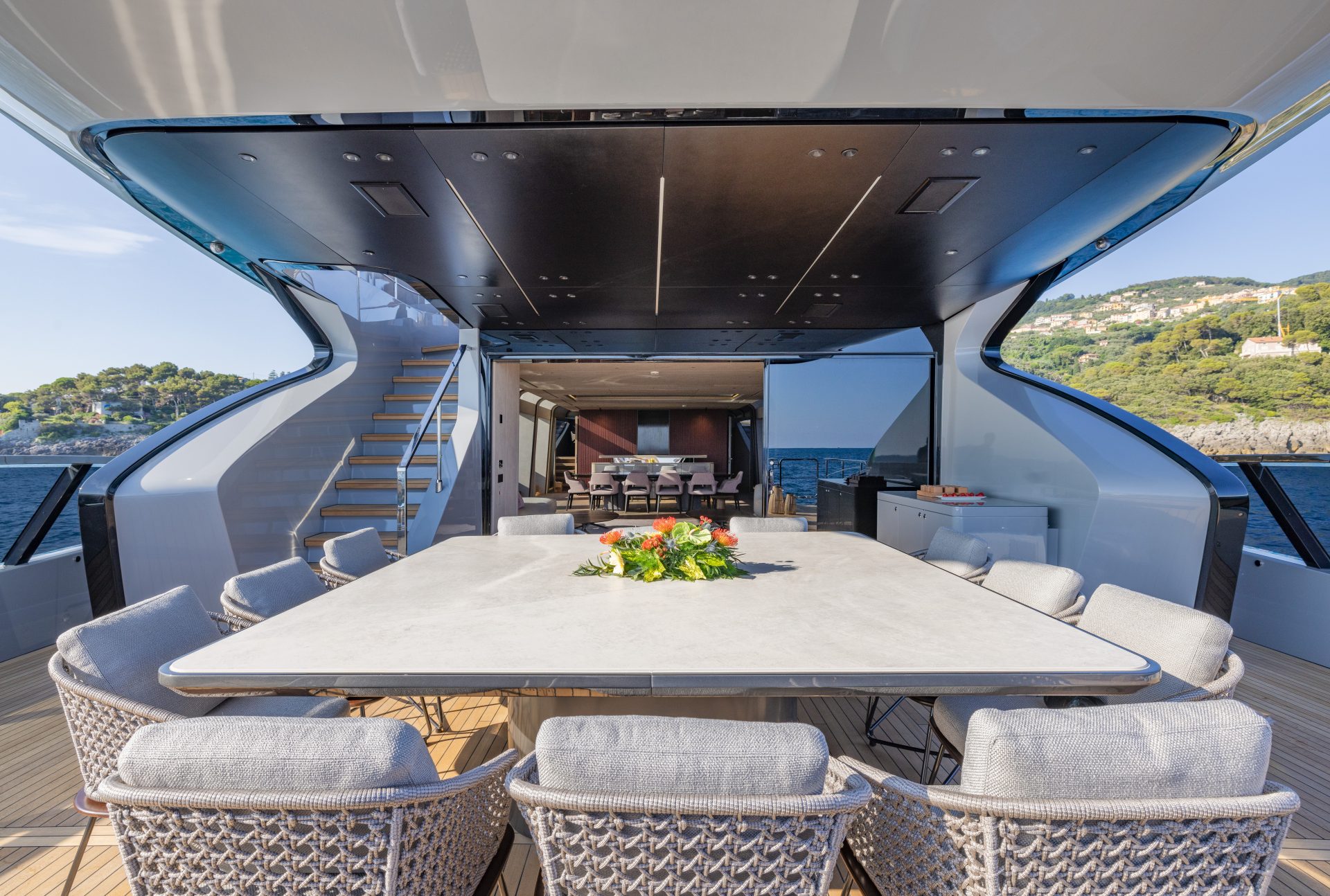 Luxurious Mangusta yacht deck with dining area.