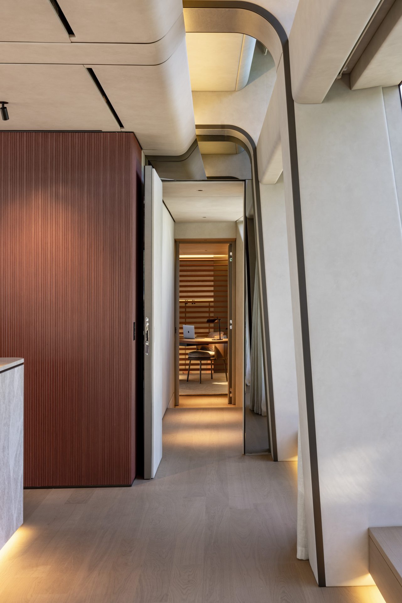 Modern yacht interior with wooden panels and sleek design.