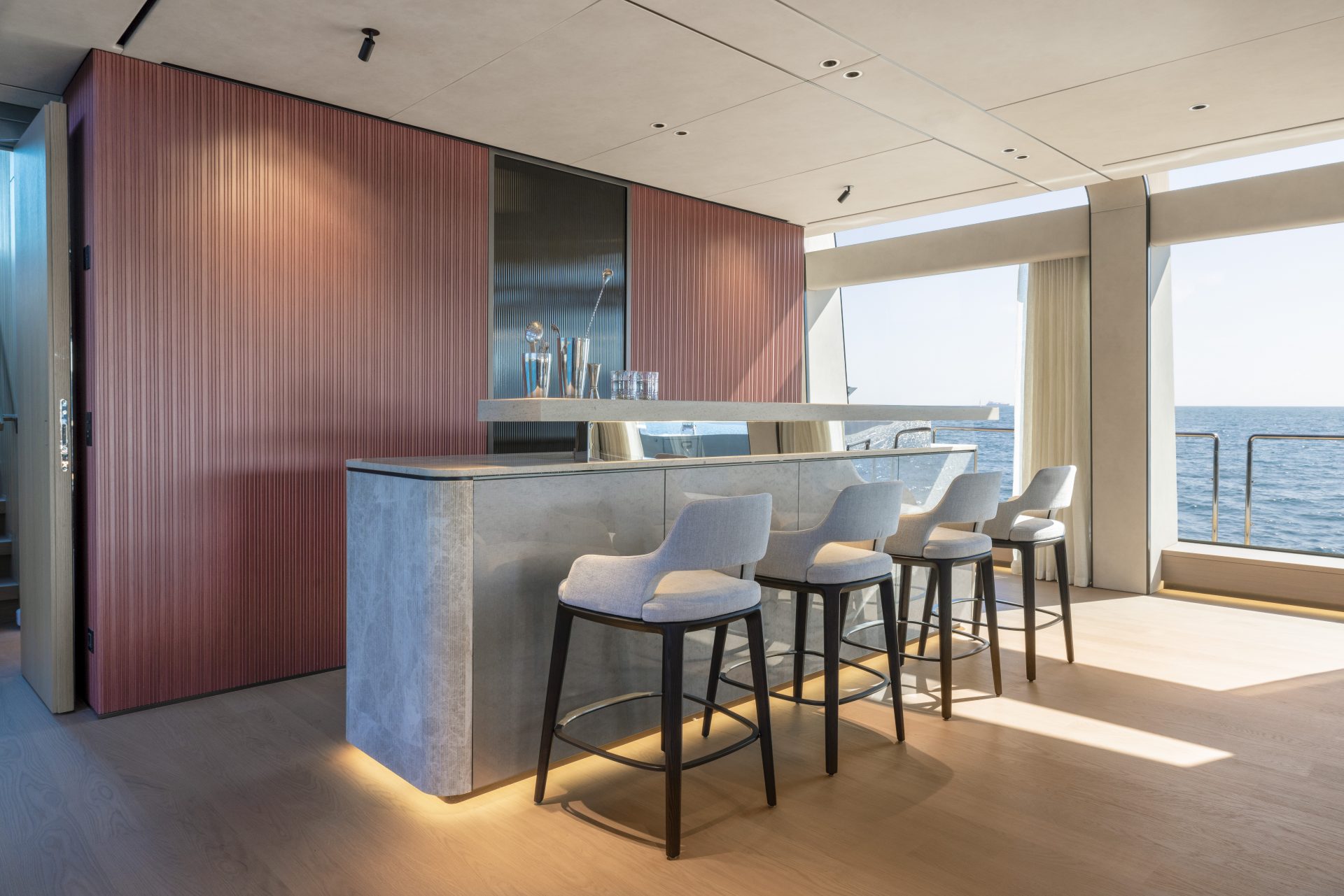 Luxury yacht interior with modern bar and ocean view.