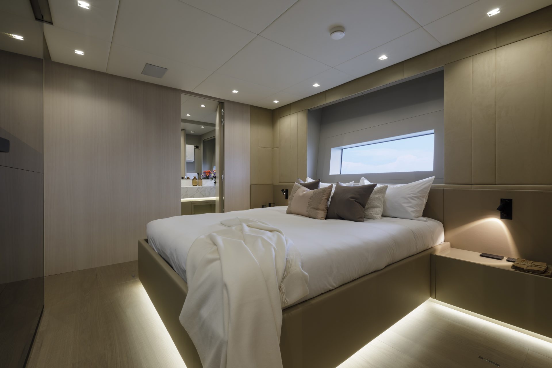 Luxury yacht cabin with elegant decor and bedding.