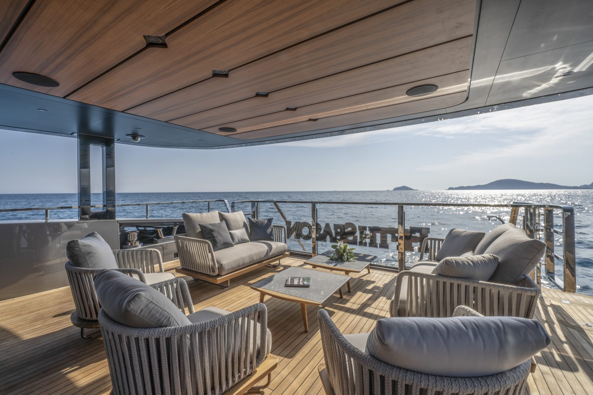 Luxury yacht deck with ocean view seating.
