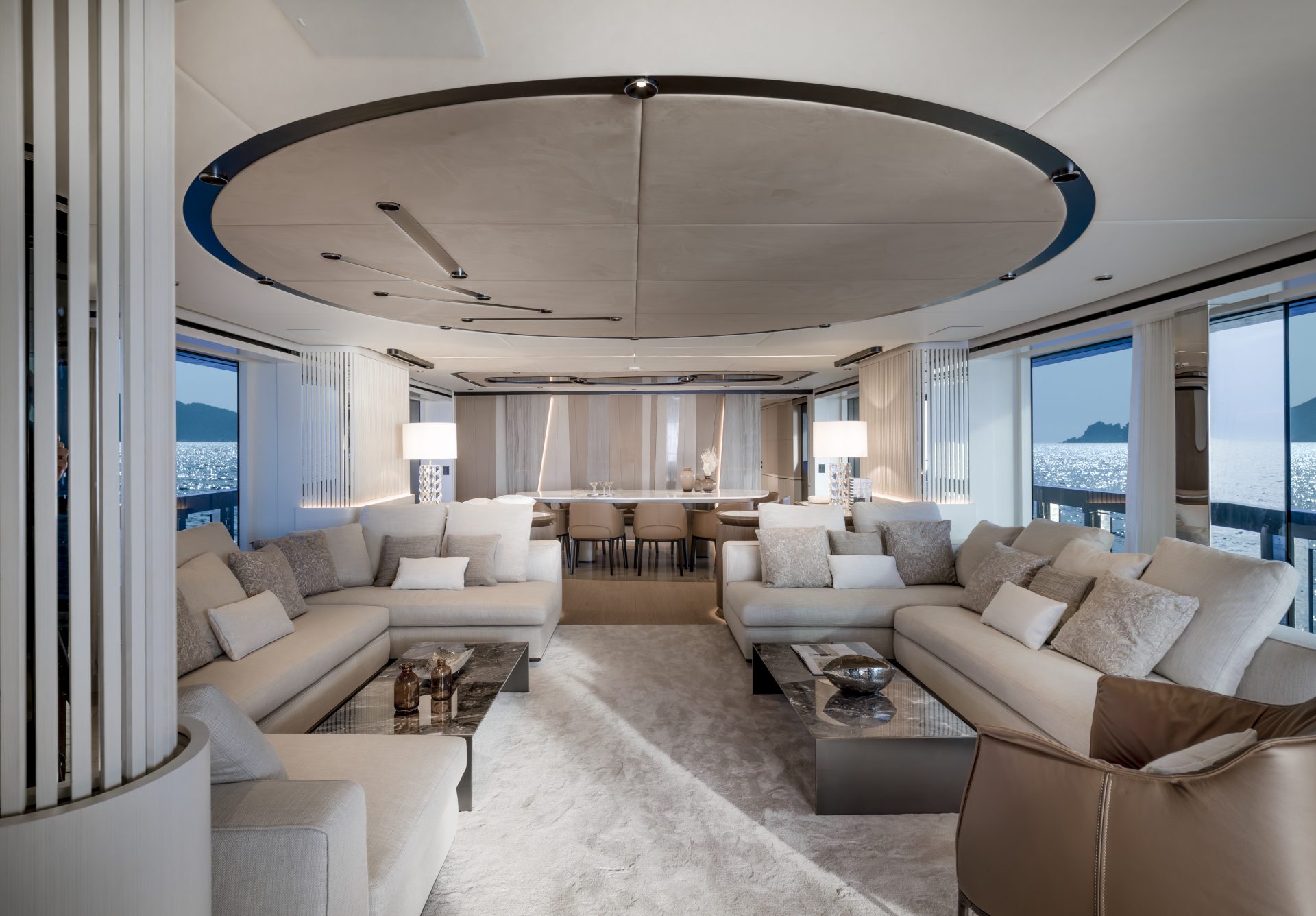 Luxurious yacht interior with elegant sofas and tables.
