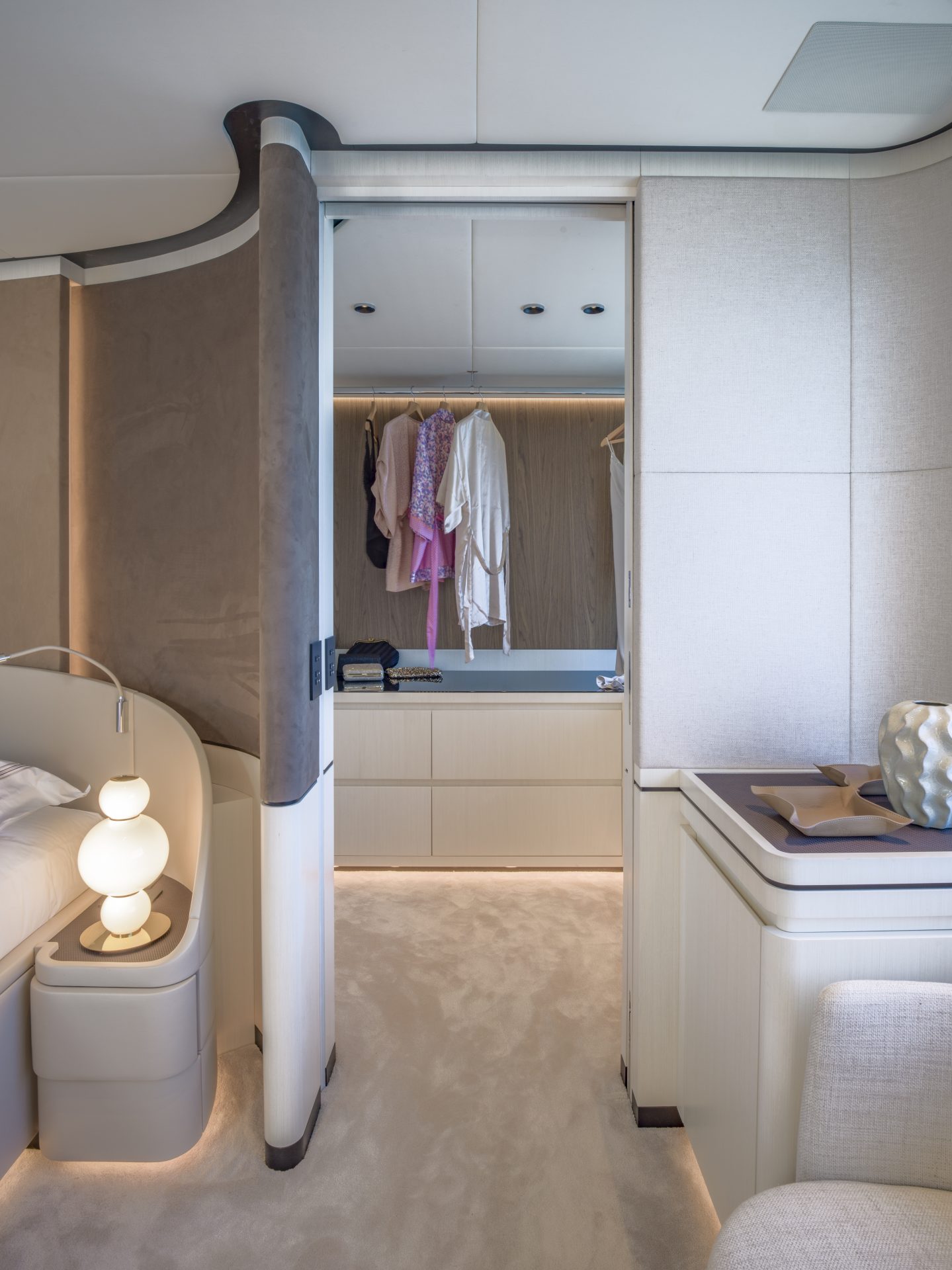 Luxurious yacht cabin with modern closet design.