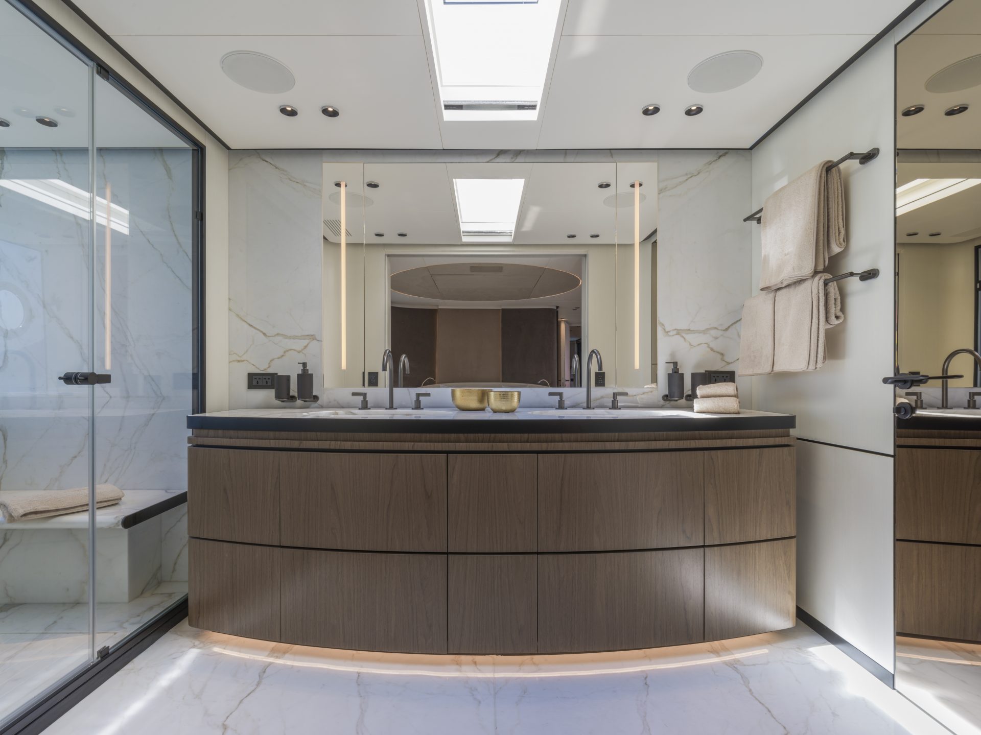 Luxury yacht bathroom with marble and wood finishes.