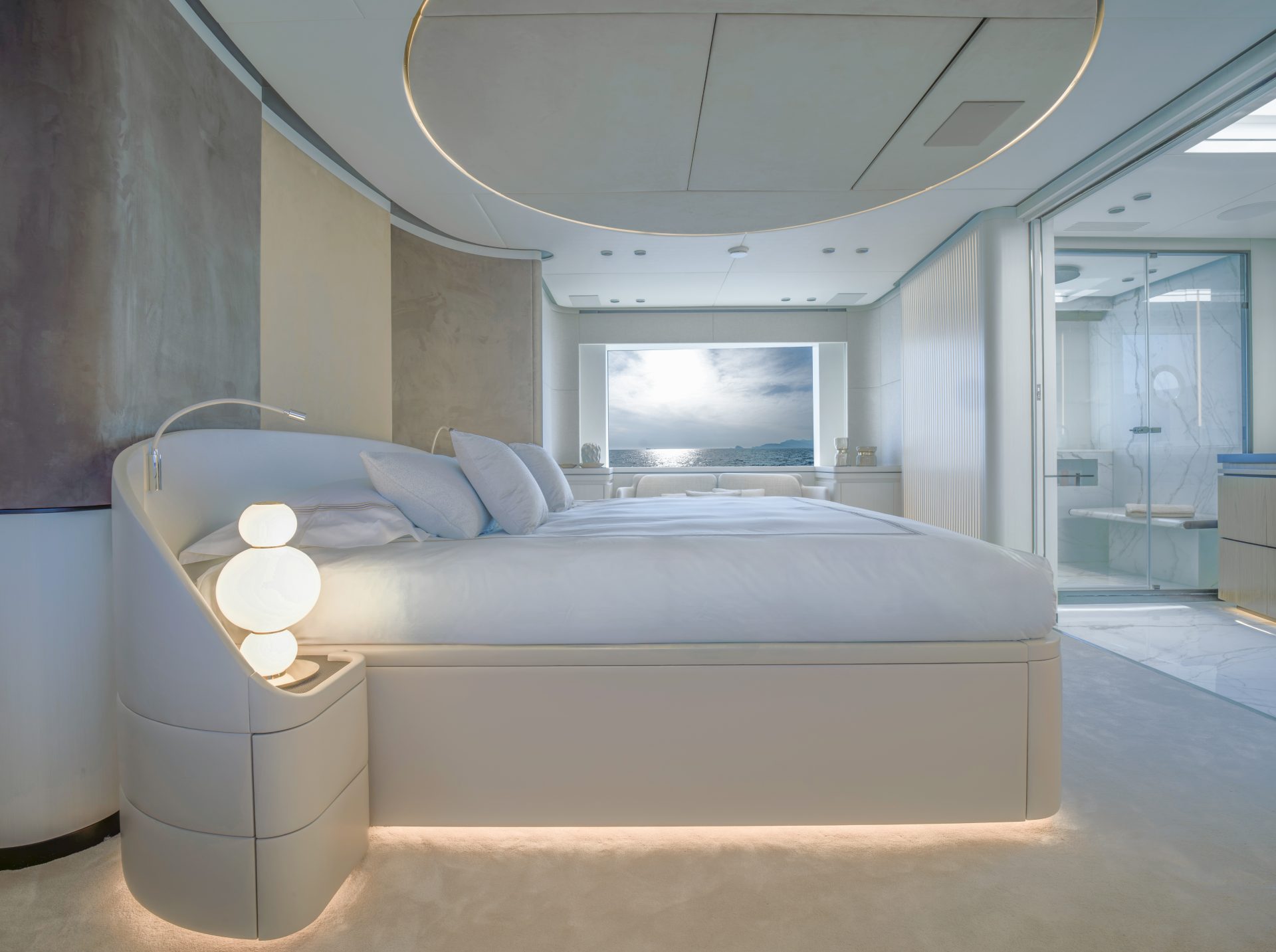 Luxury yacht bedroom with ocean view and modern design.