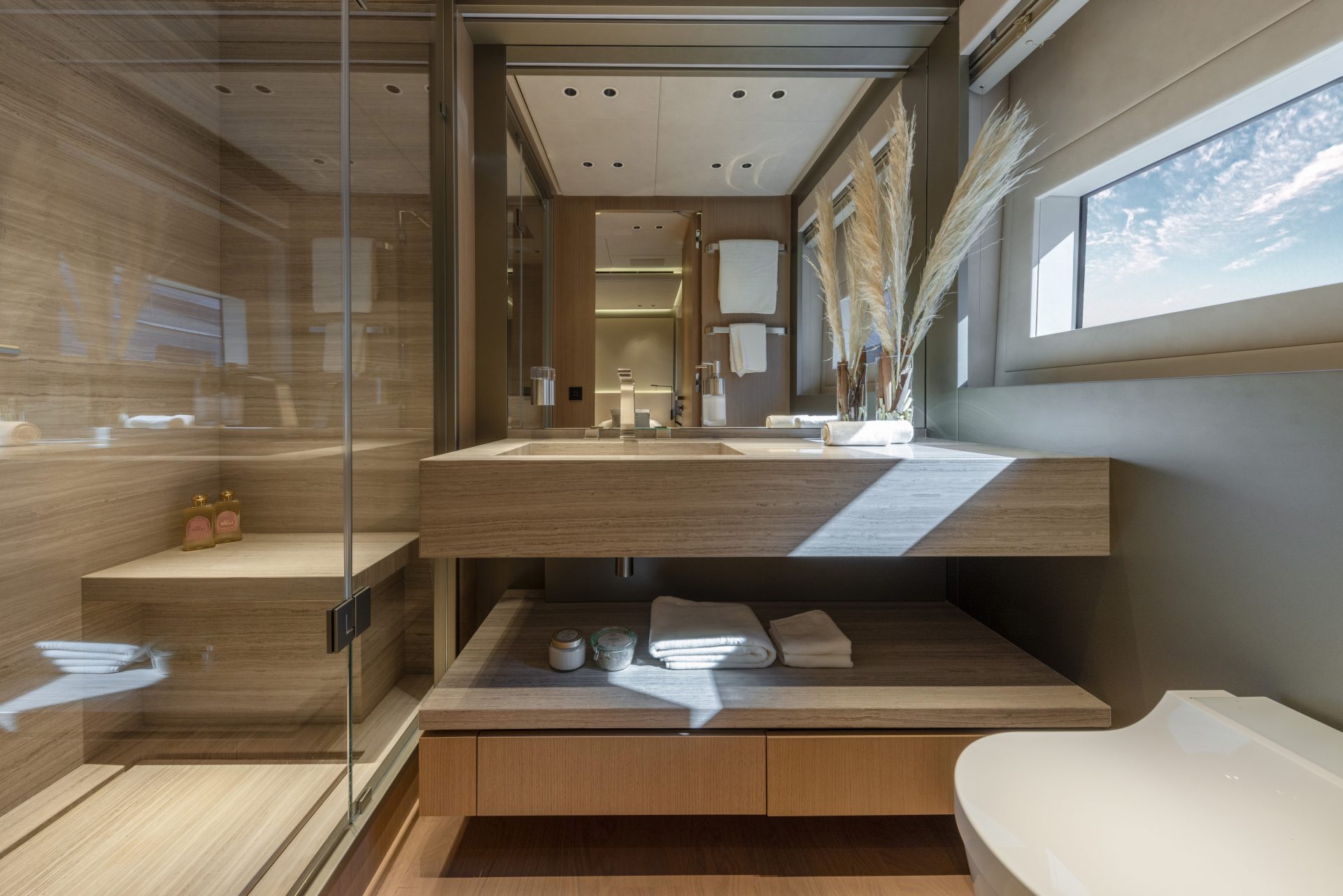 Luxury yacht bathroom with modern design and wood finishes.