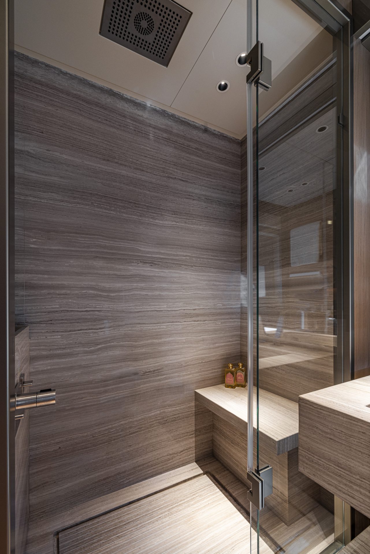 Luxurious yacht sauna with glass door and wood finish