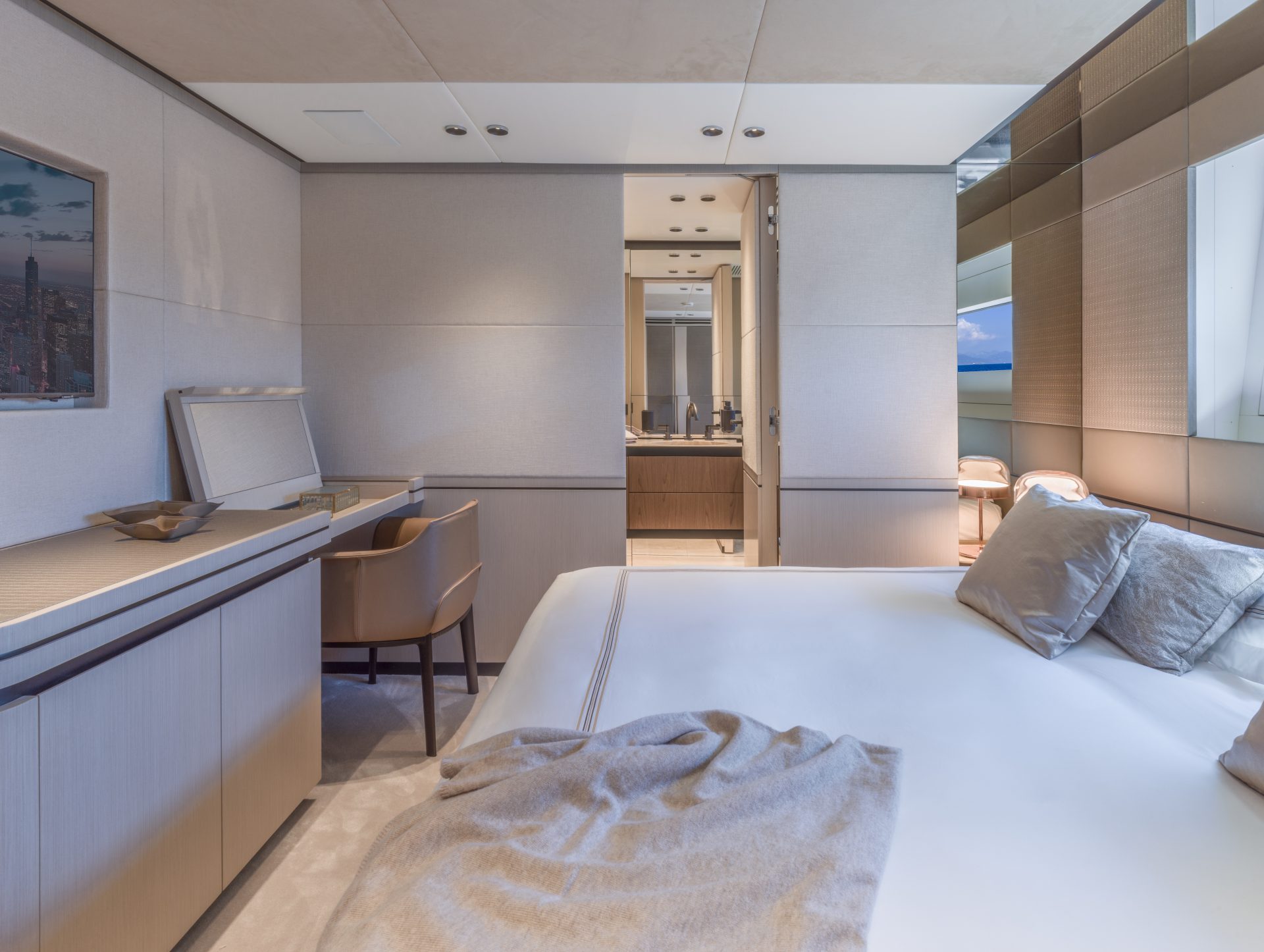 Luxury yacht bedroom with modern furnishings.