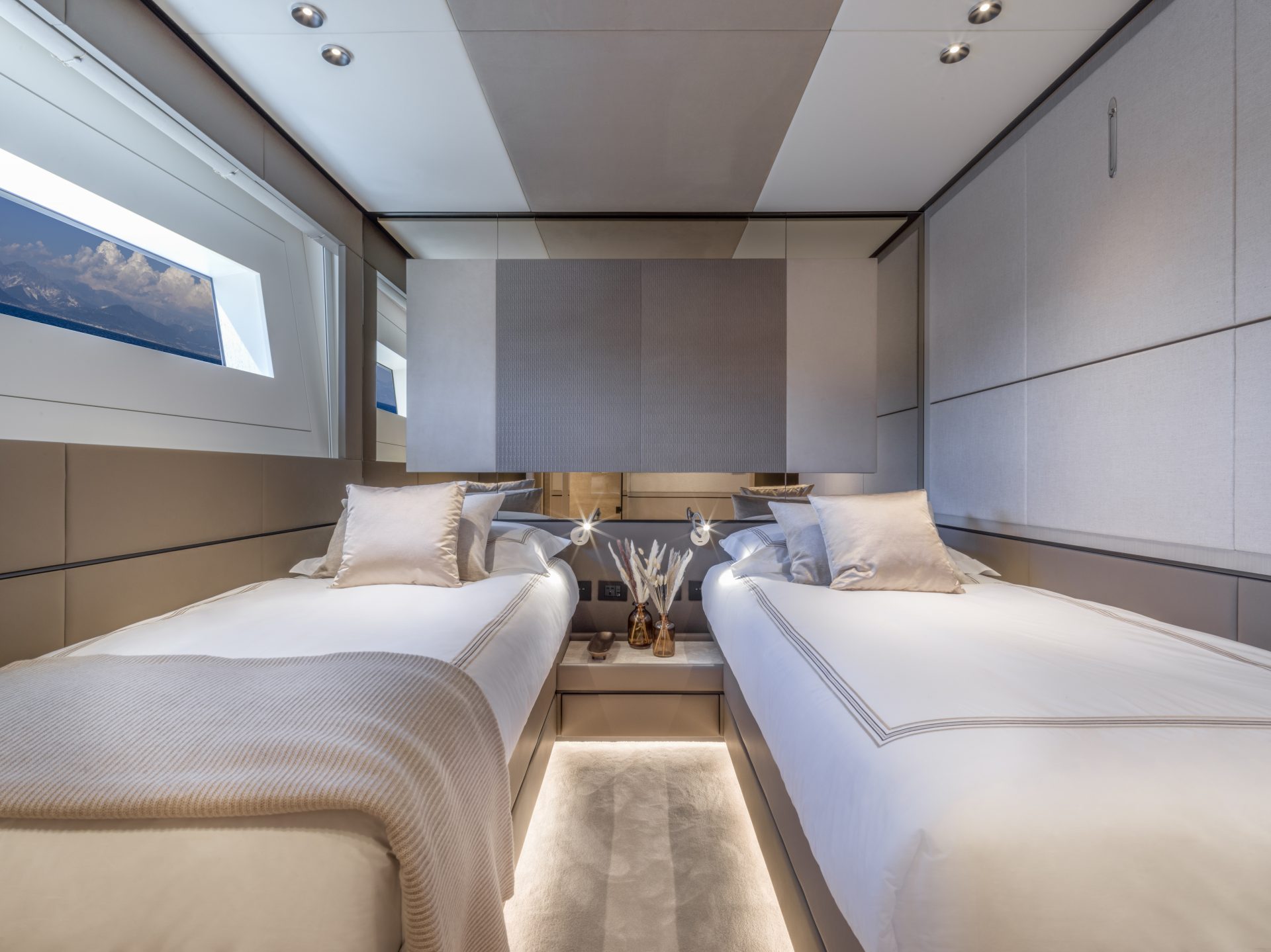 Luxurious twin bedroom in Mangusta yacht cabin.