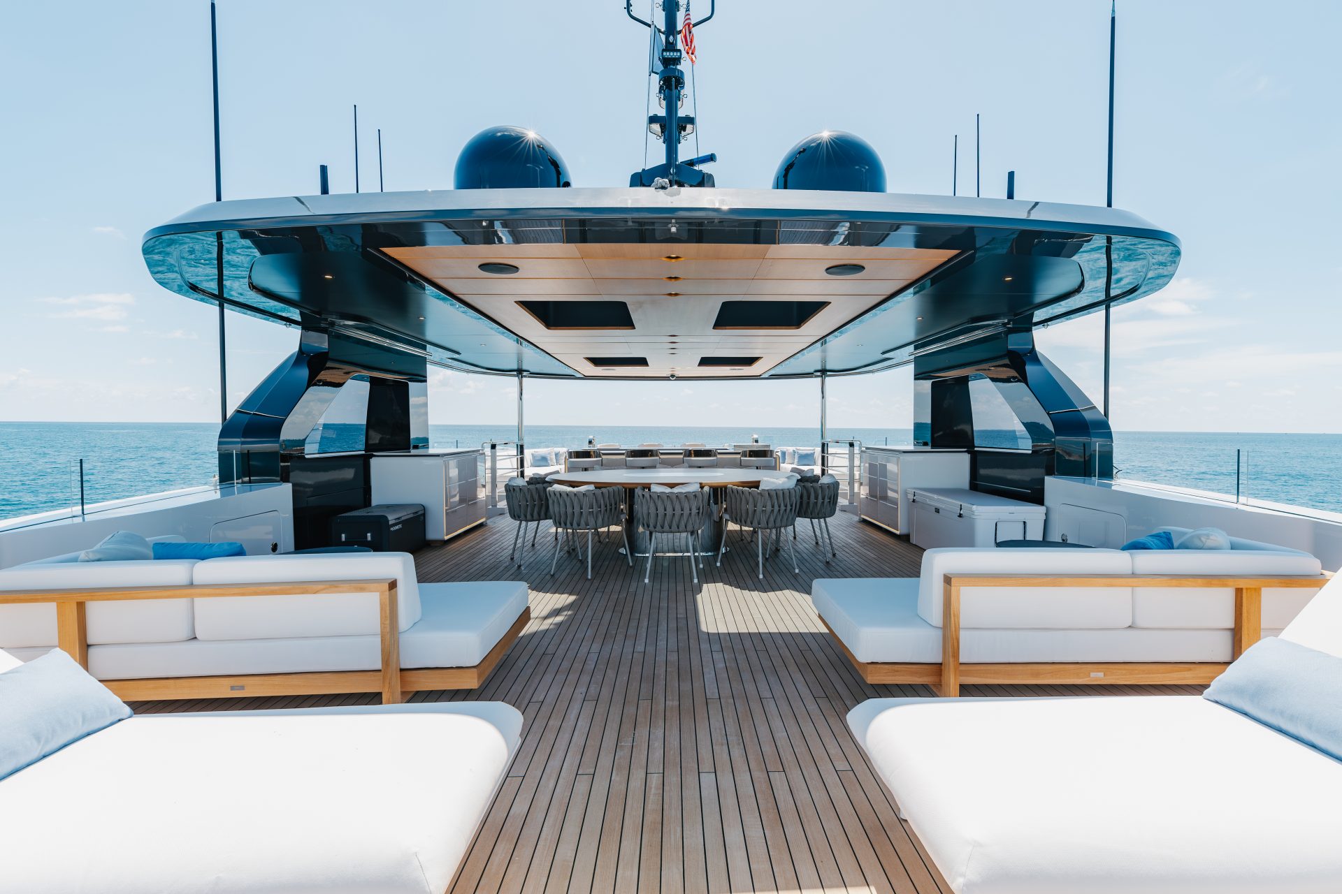 Spacious deck on luxury Mangusta yacht at sea.