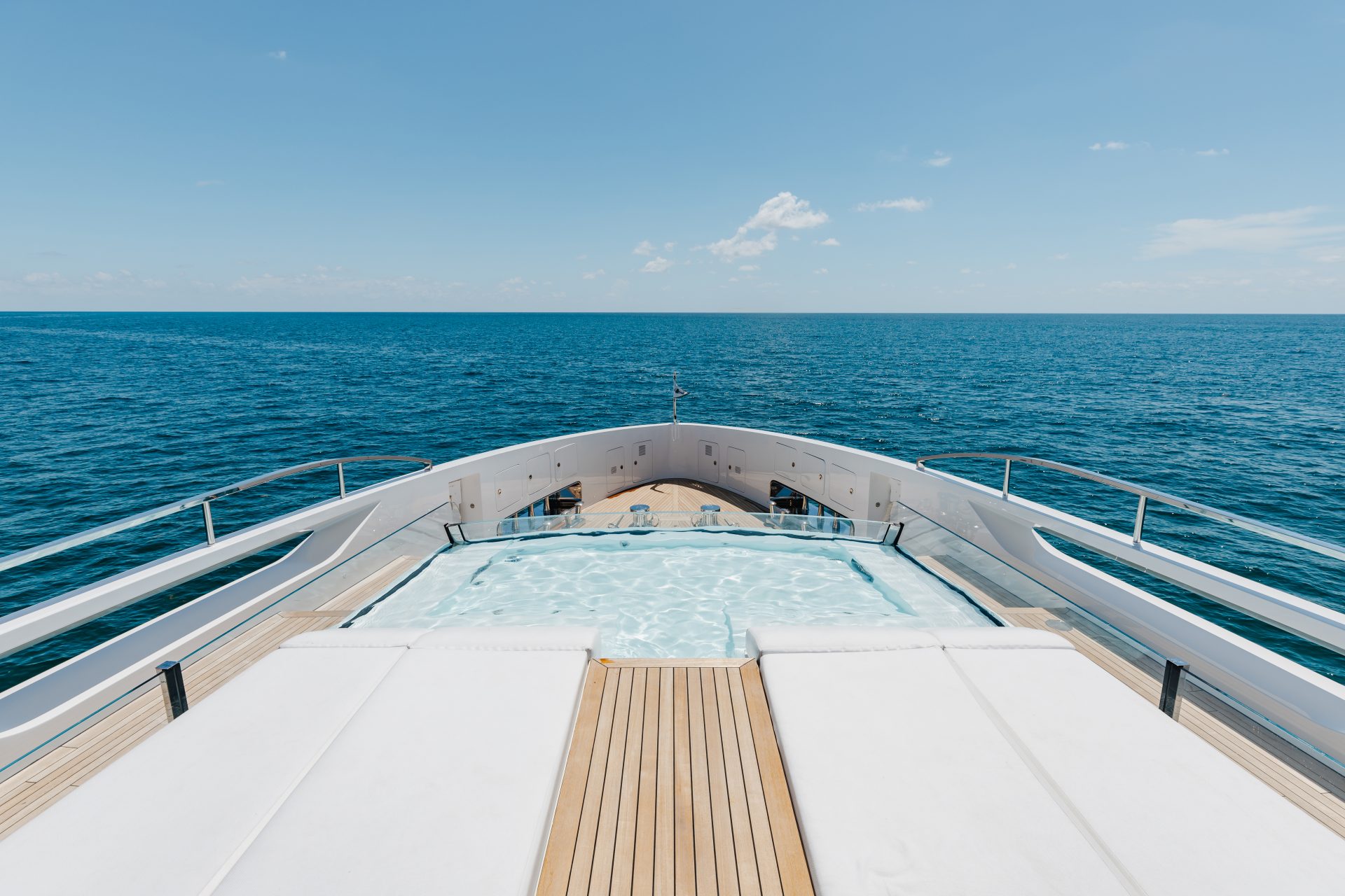 Deck pool view on Mangusta yacht, open sea background